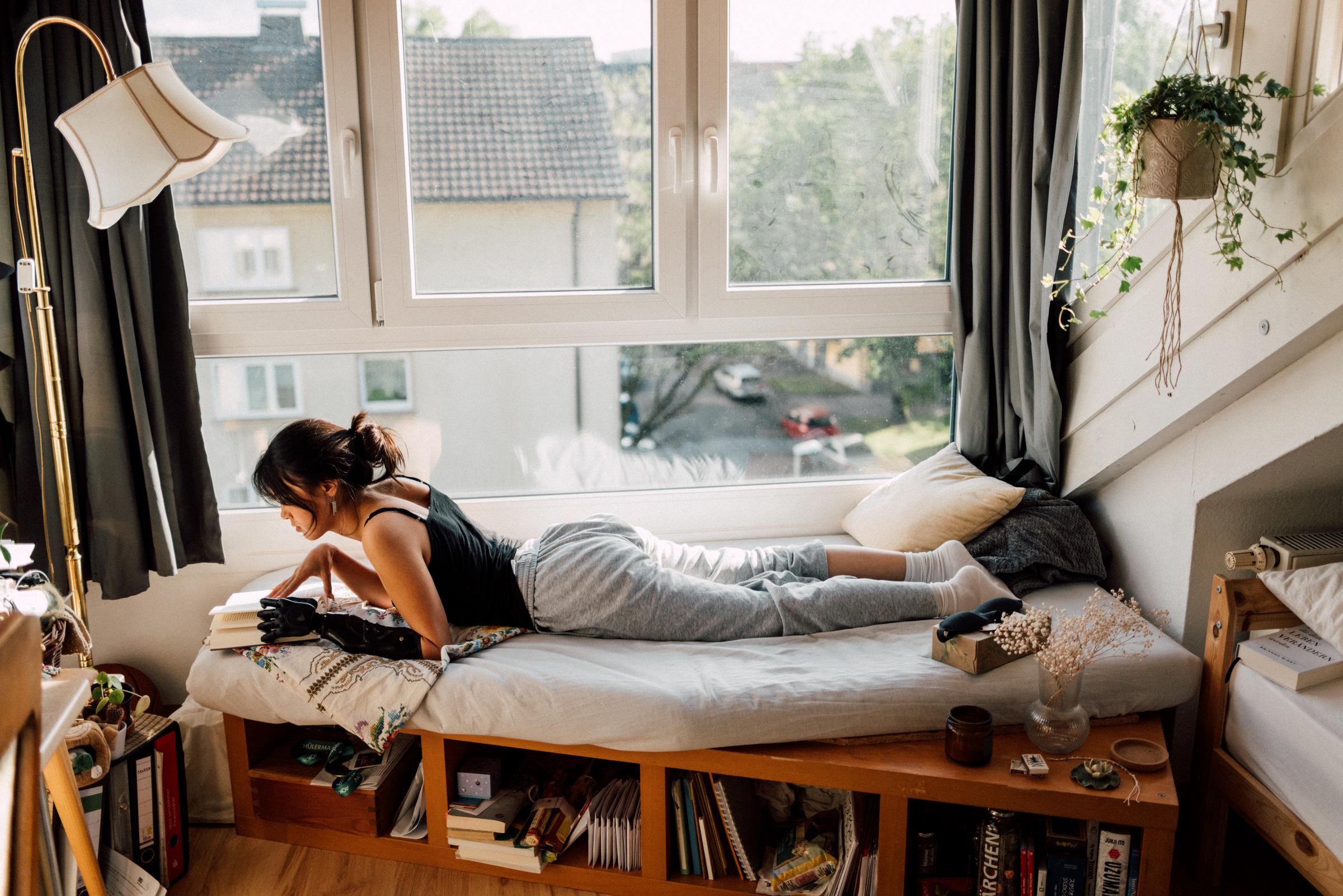 A woman relaxing in her bedroom and reading a book | Source: Getty Images