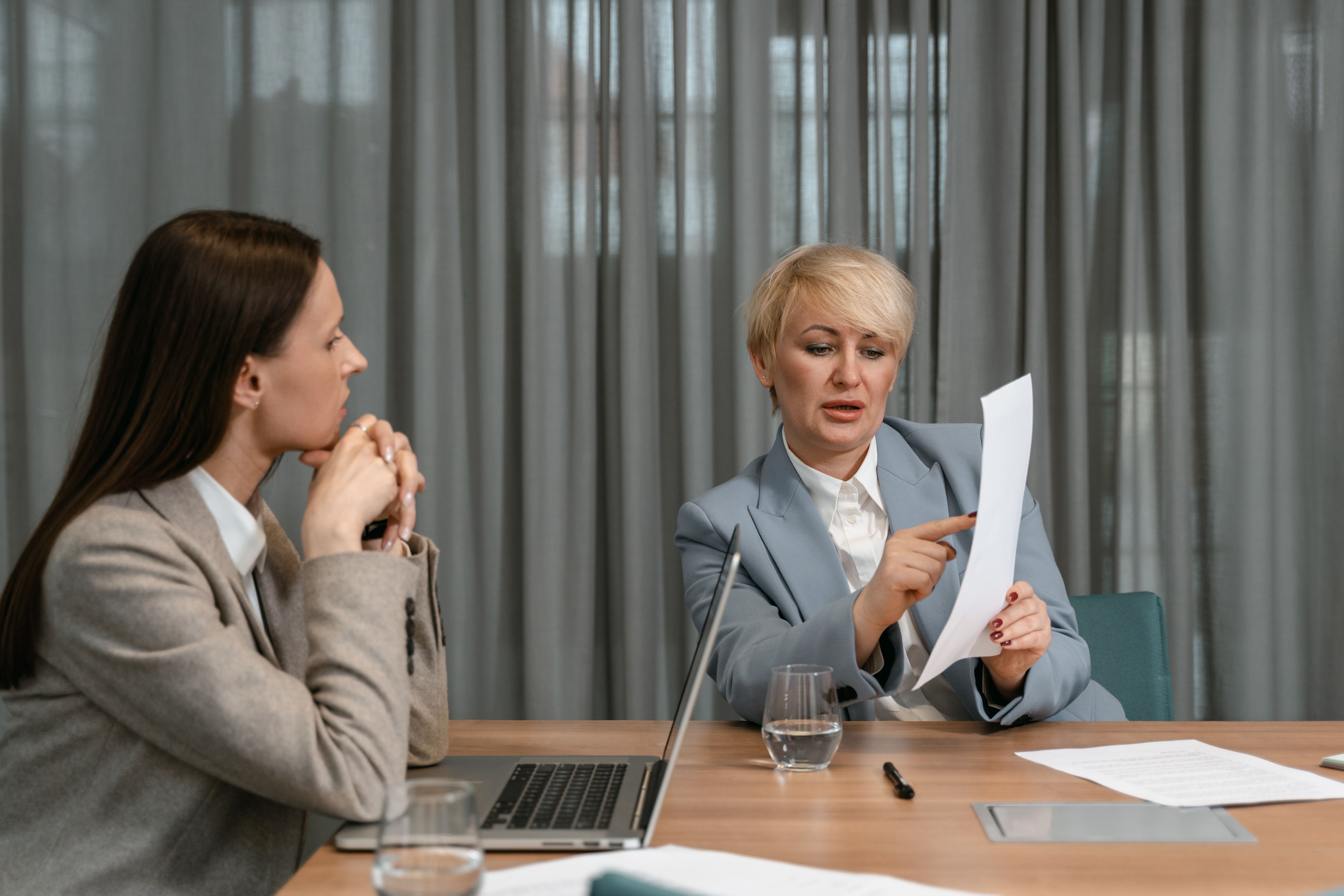 A woman explaining something to a coworker during a meeting | Source: Pexels
