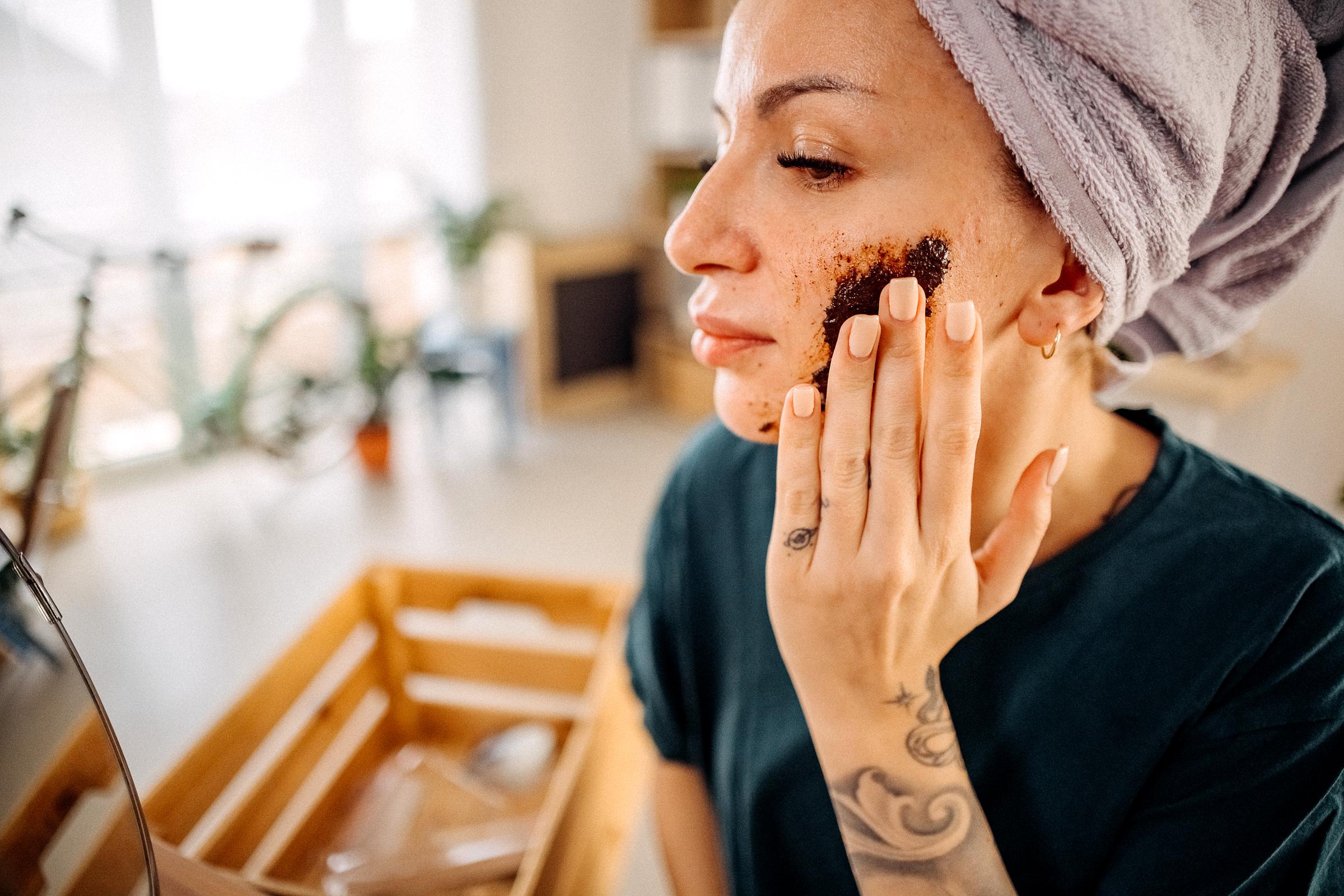 A woman applying a facial scrub | Source: Getty Images
