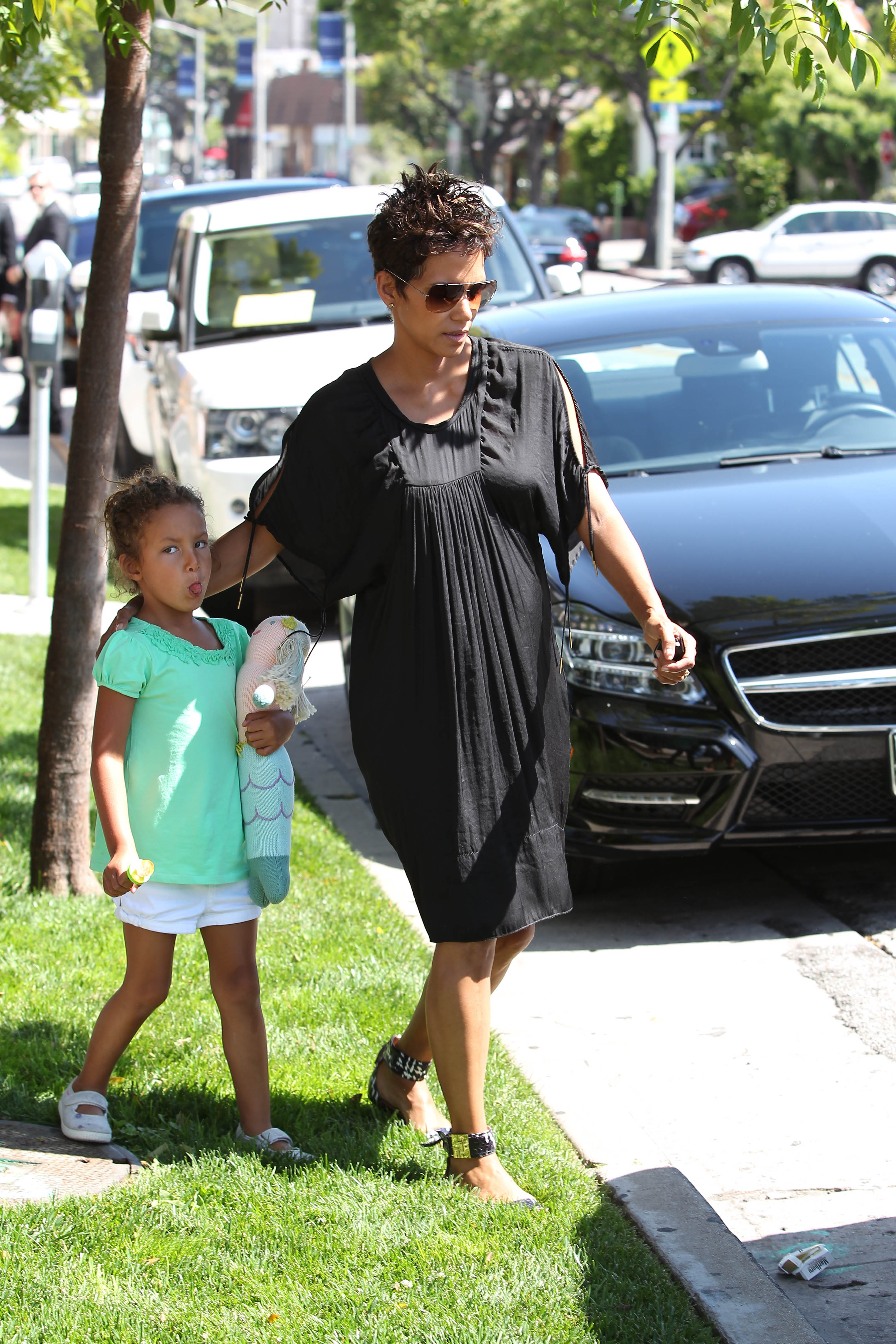 Little Nahla playfully stuck out her tongue while carrying a mermaid doll during a walk with Halle Berry — a sweet glimpse of the carefree childhood her mother fought to protect. | Source: Getty Images.