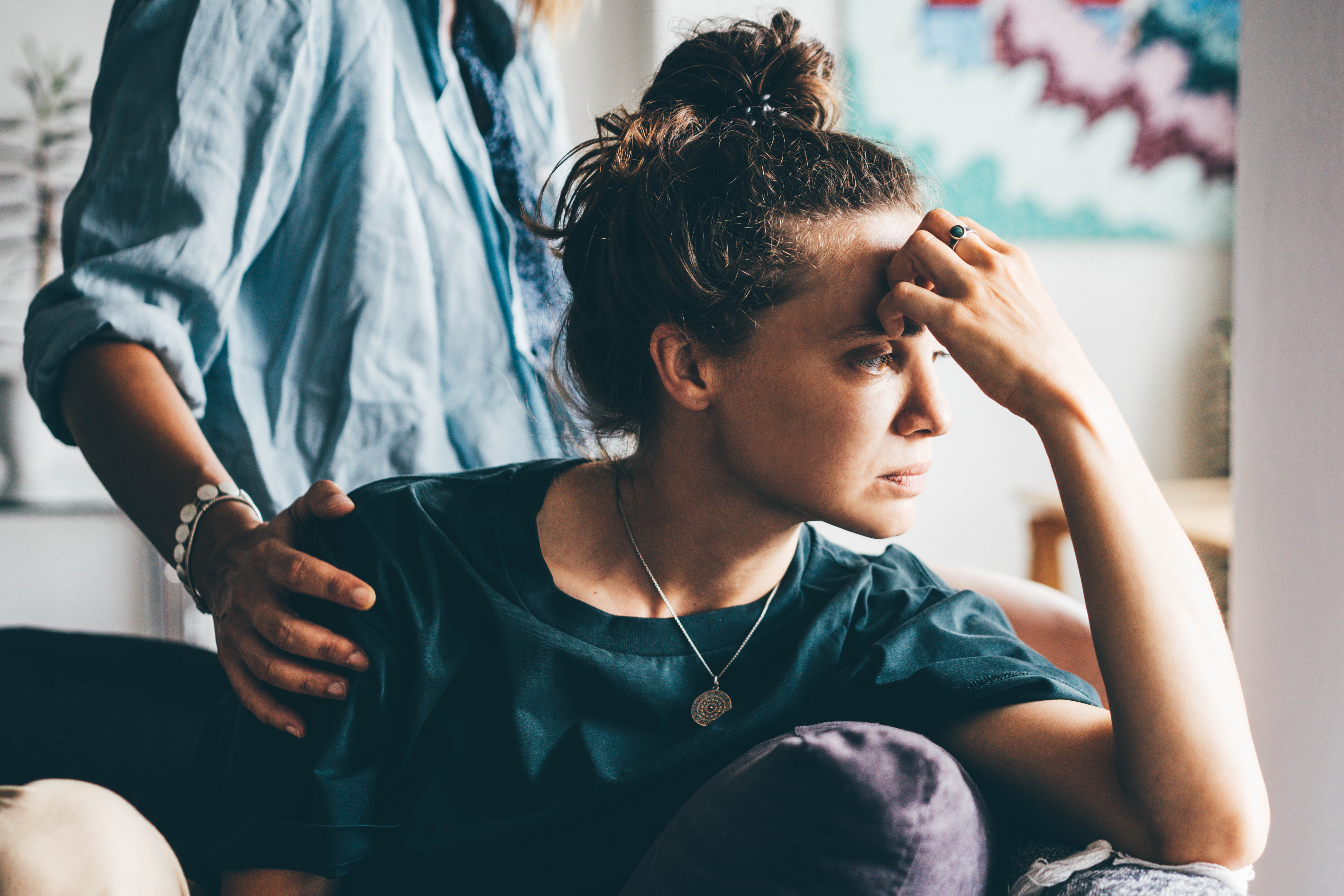 An upset woman being consoled. | Source: Getty Images