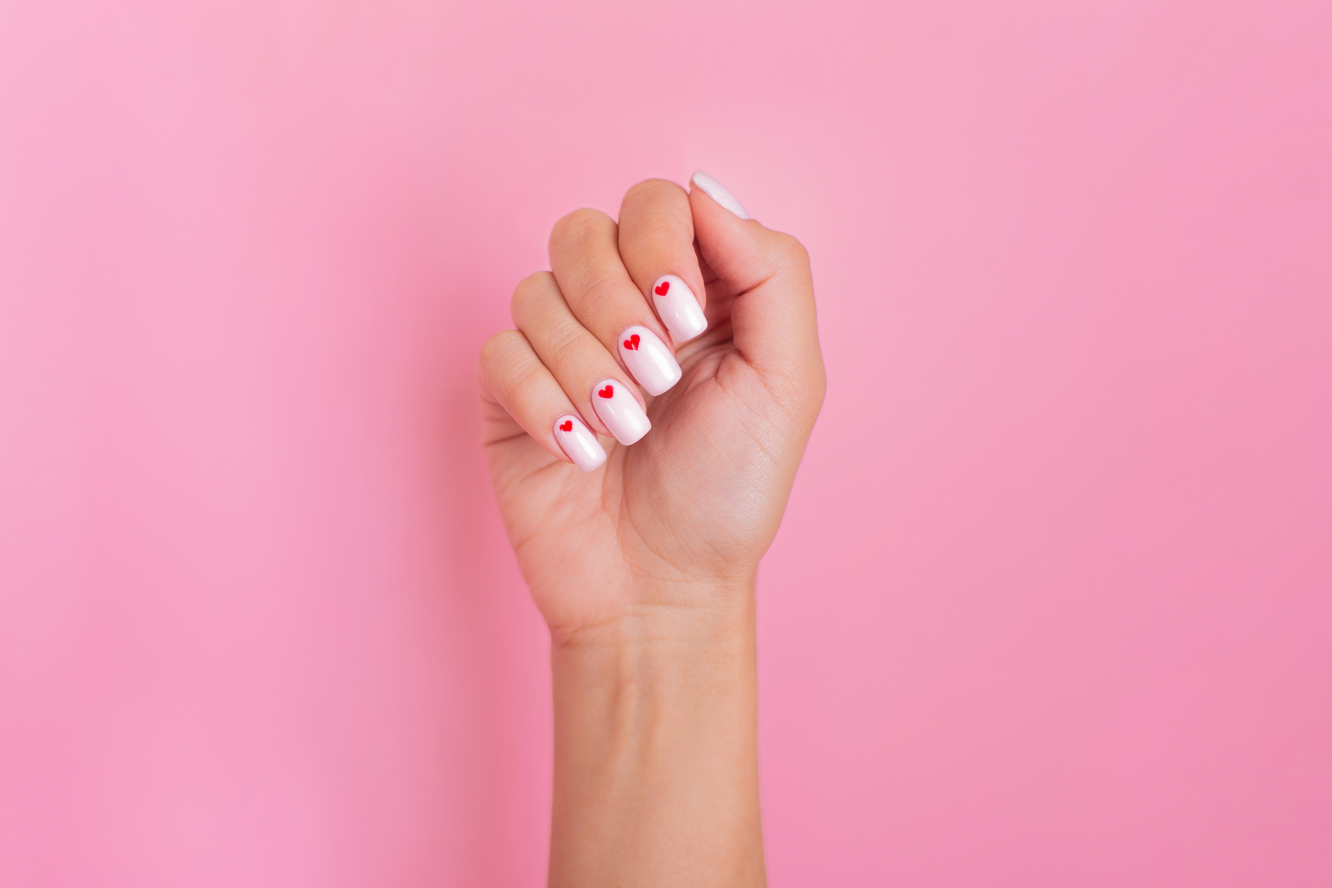 Pink nails with red hearts. | Source: Getty Images