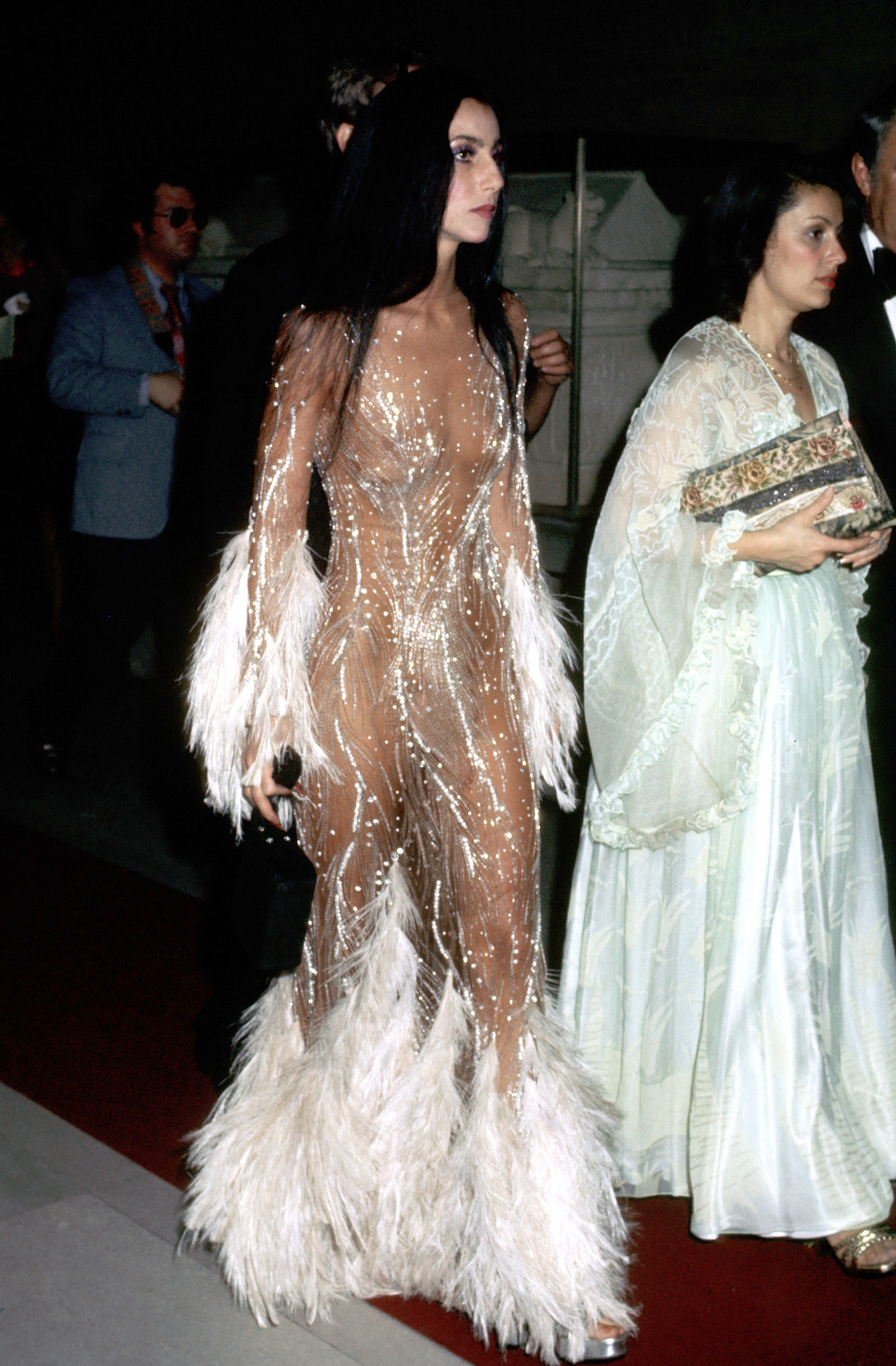Cher wearing a nude, crystal-embellished gown at the Met Gala in 1974 | Source: Getty Images
