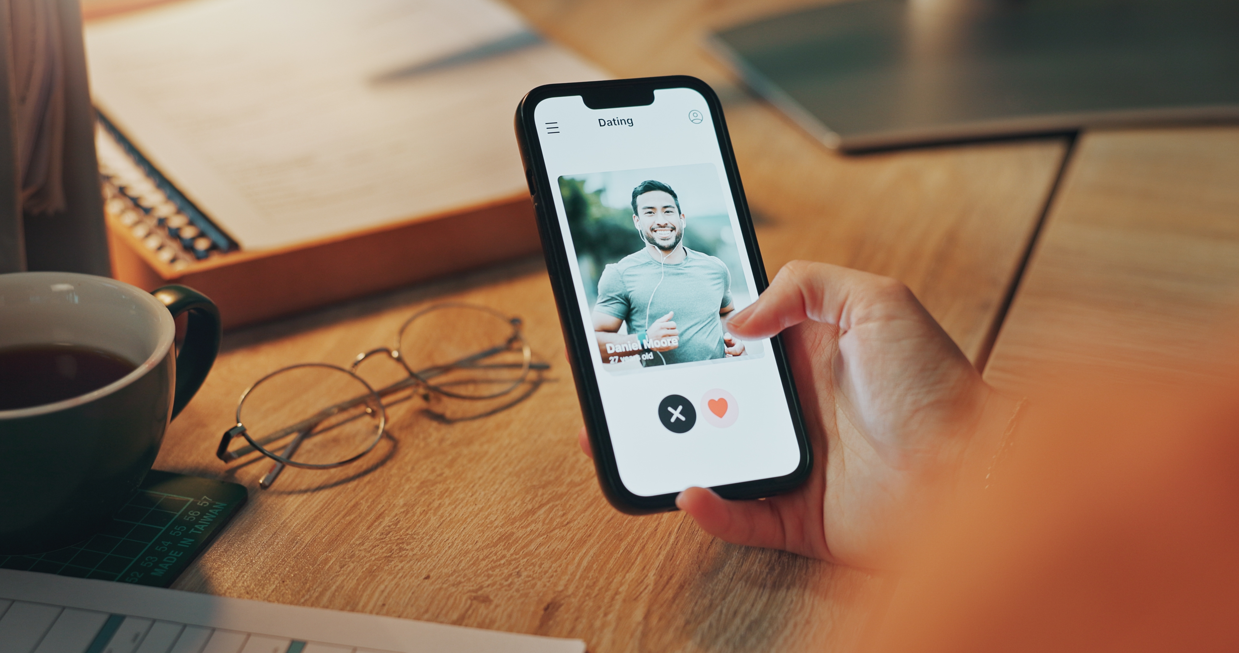 Phone screen, a person's hand and person on dating app | Source: Shutterstock