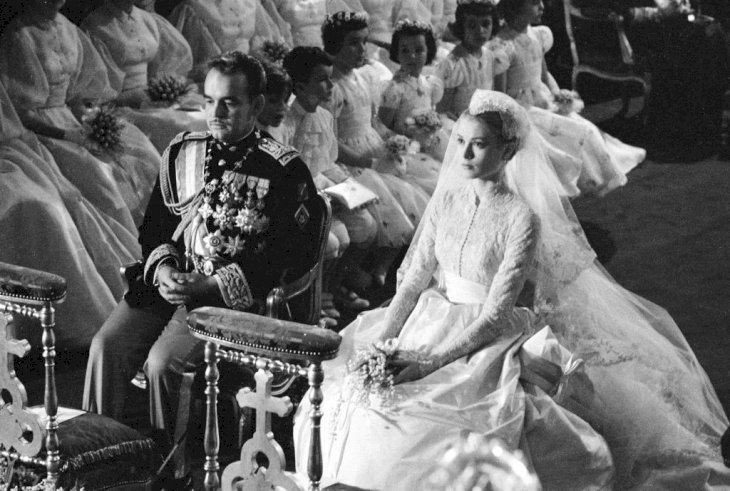 Prince Rainier of Monaco and American actress Grace Kelly (1929 - 1982) sit before the altar during their wedding ceremony at the Cathedral of Saint Nicholas, Monte Carlo, Monaco, April 19, 1956. Kelly's gown was designed by costume designer Helen Rose. (Photo by Thomas McAvoy/The LIFE Picture Collection via Getty Images)