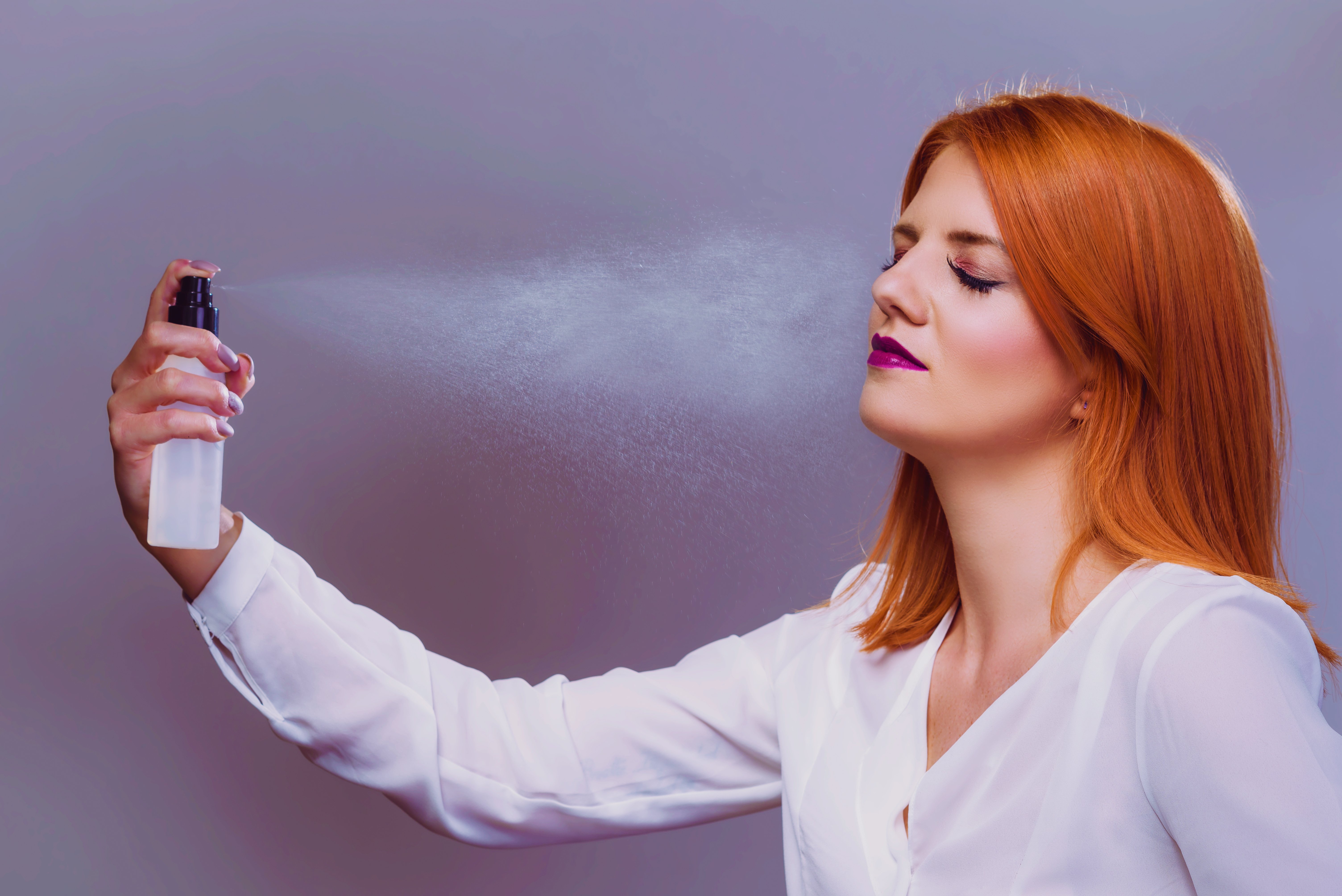 Woman using a setting spray after applying makeup | Source: Shutterstoock