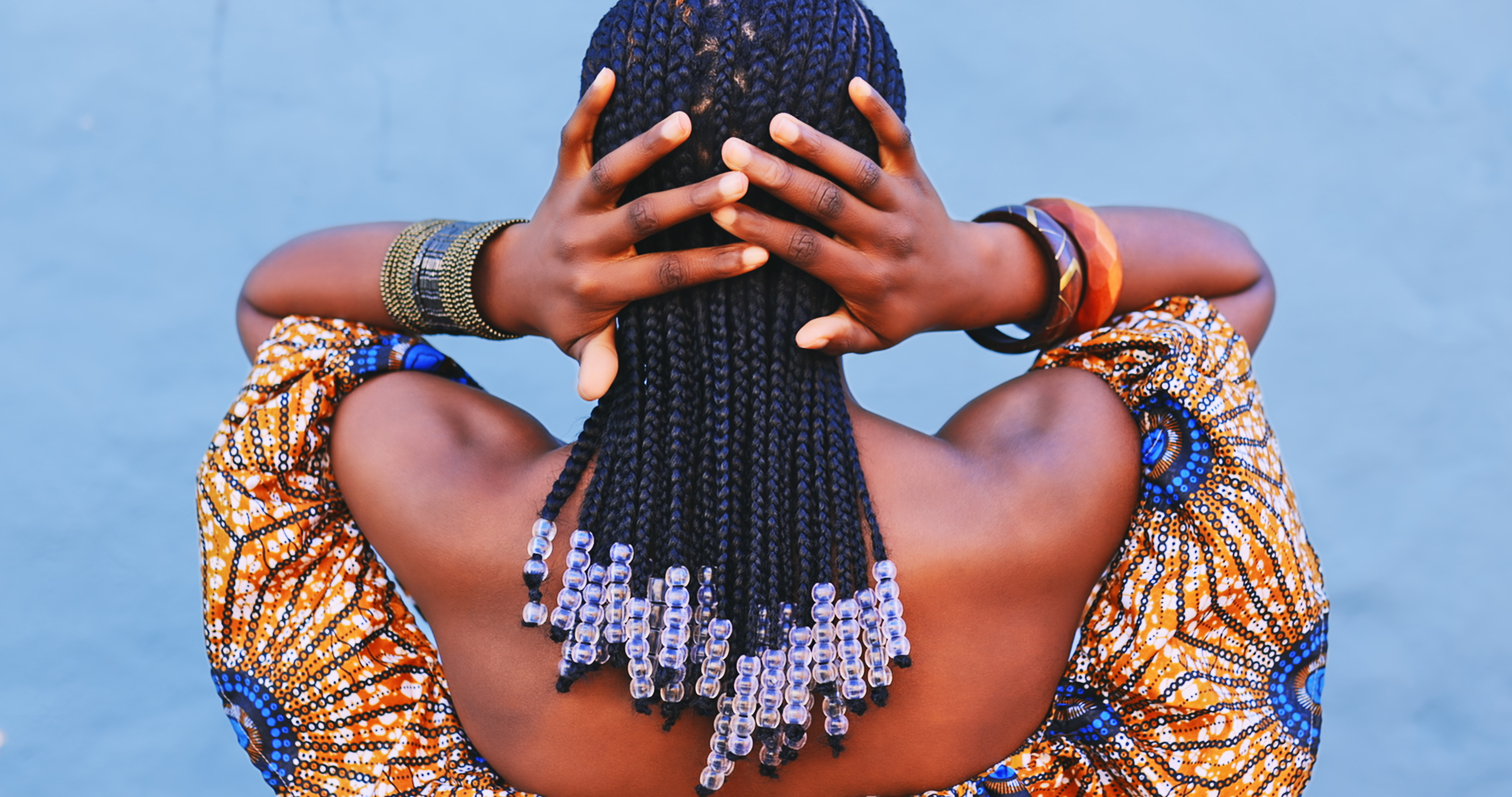 A woman with Fulani braids decorated with clear, plastic beads. | Source: Getty Images
