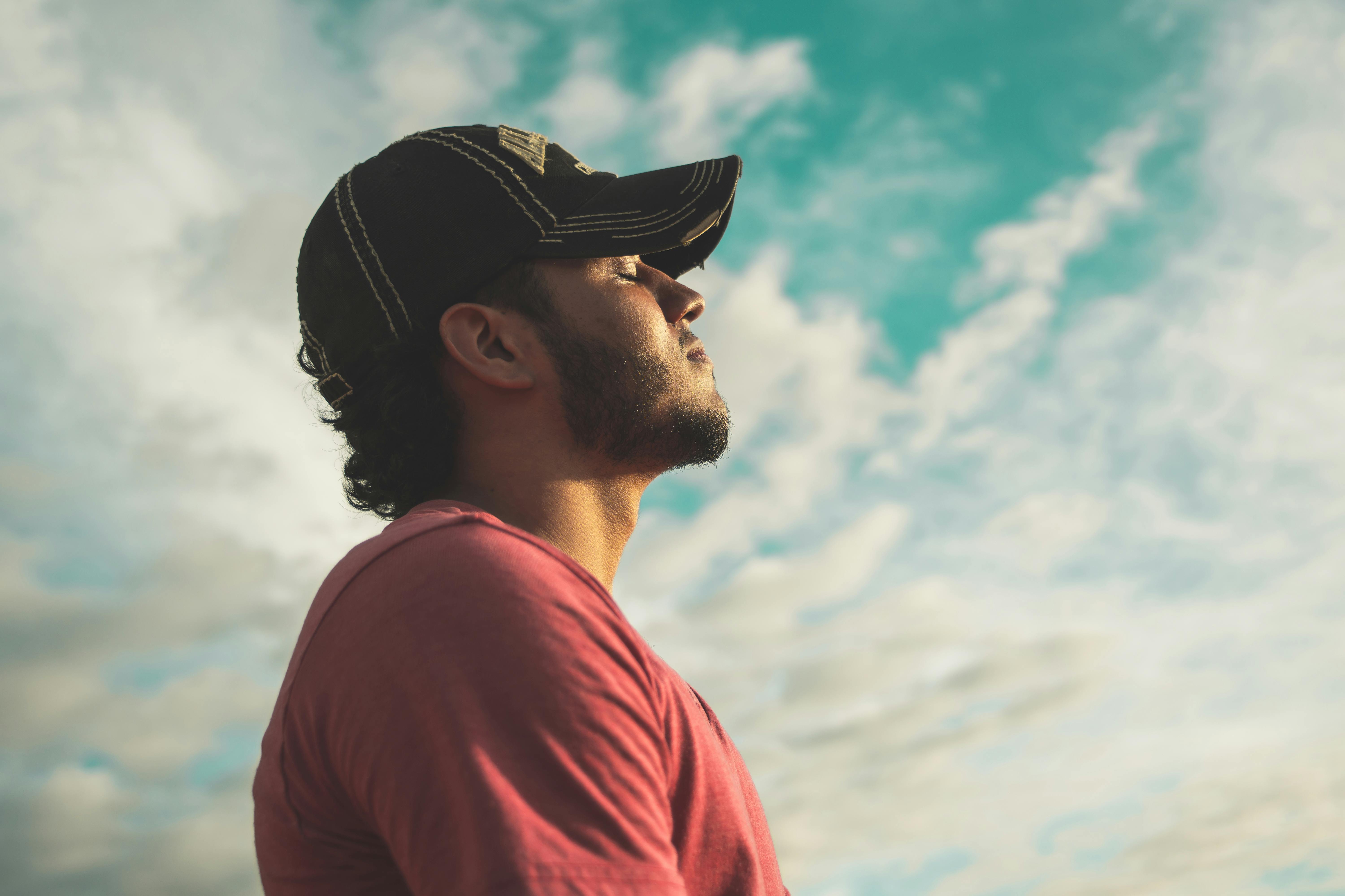 A man closes his eyes as he basks in the sun. | Source: Pexels