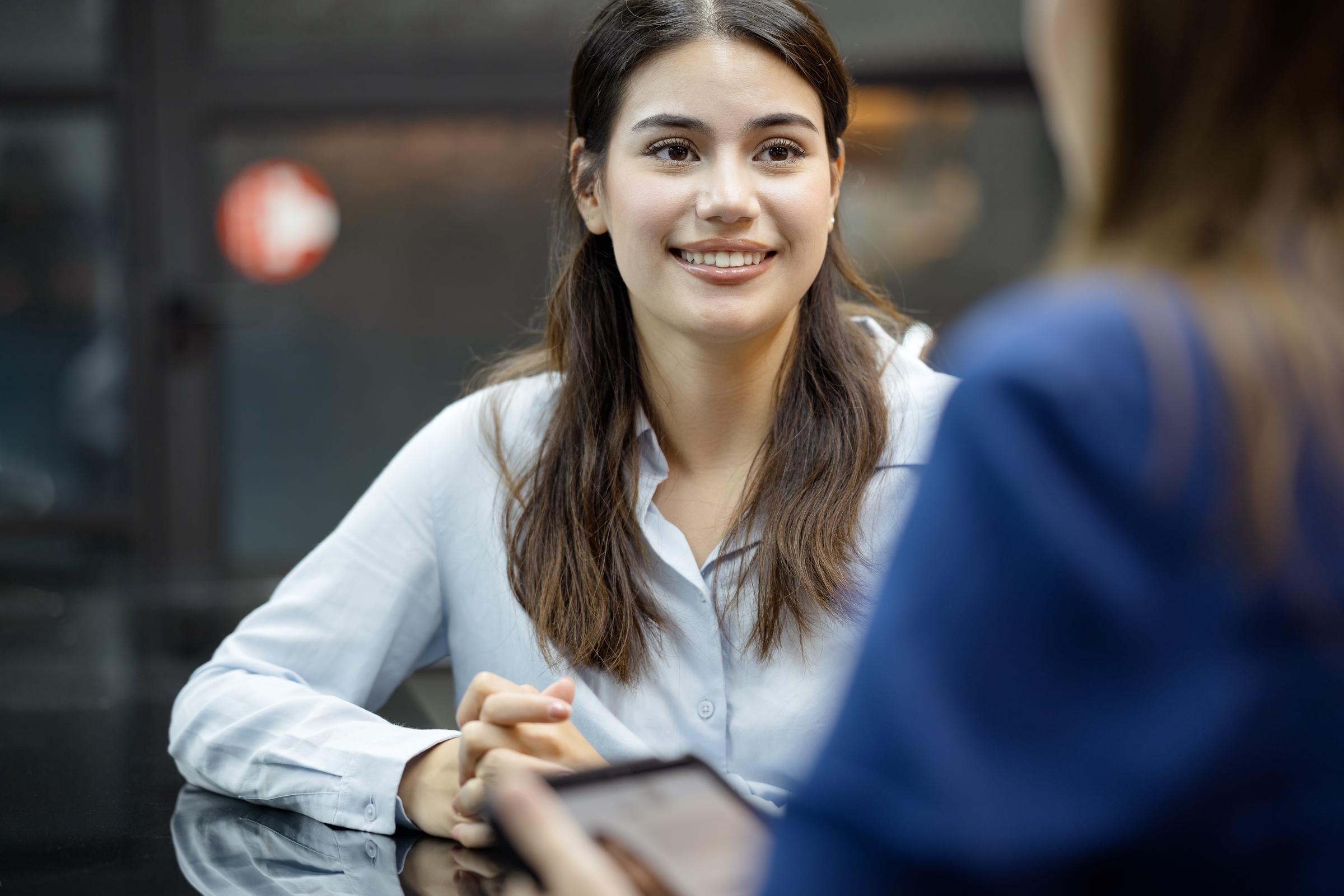 A woman listening to her manager during a meeting | Source: Getty Images
