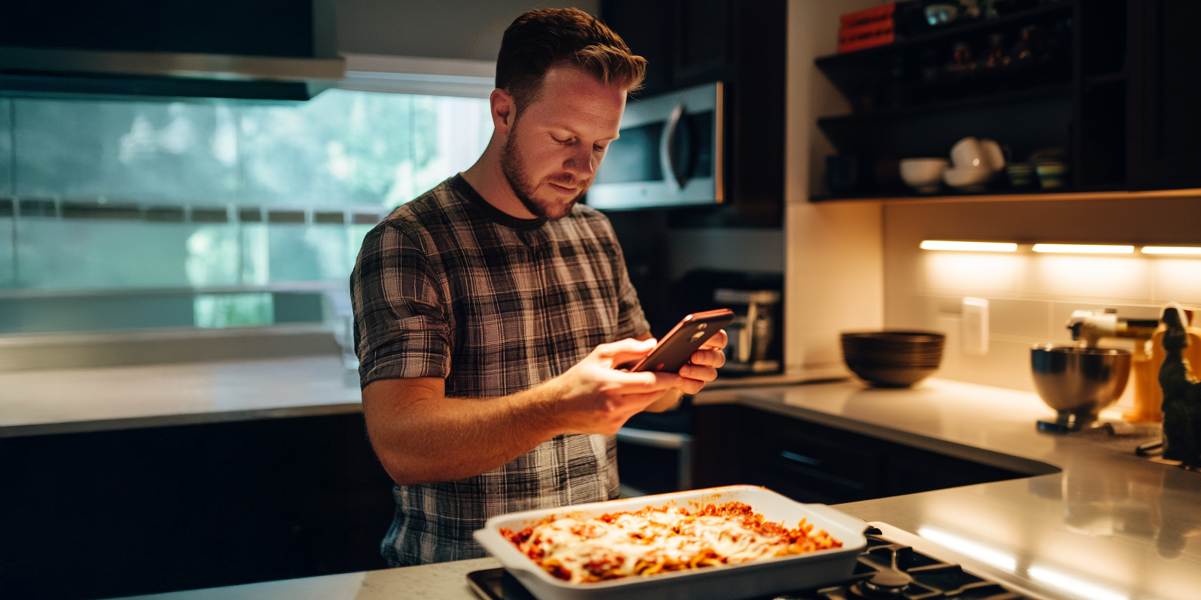 A man taking a photo of lasagna | Source: Amomama