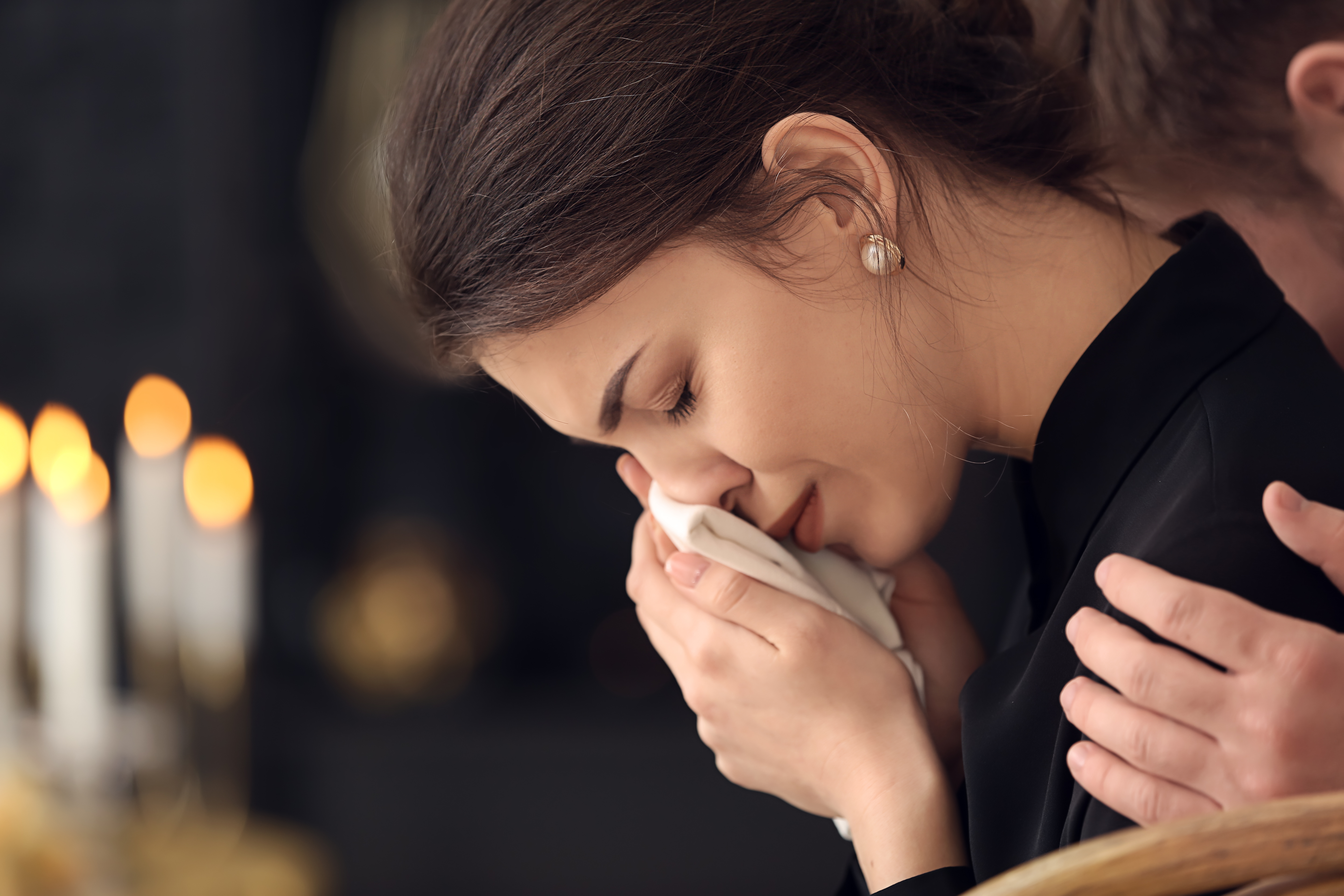 A young lady at a funeral | Source: Shutterstock