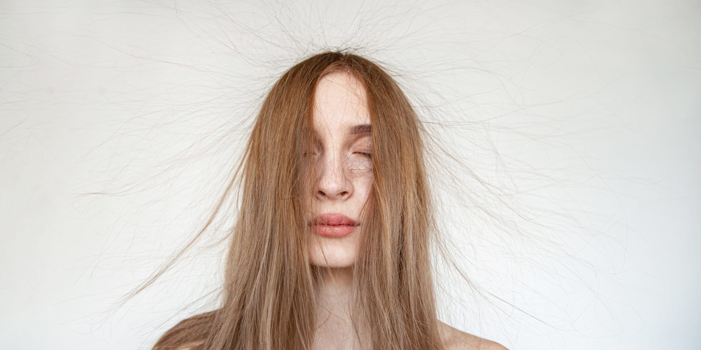 A woman's hair strands rising due to static electricity | Source: Getty Images