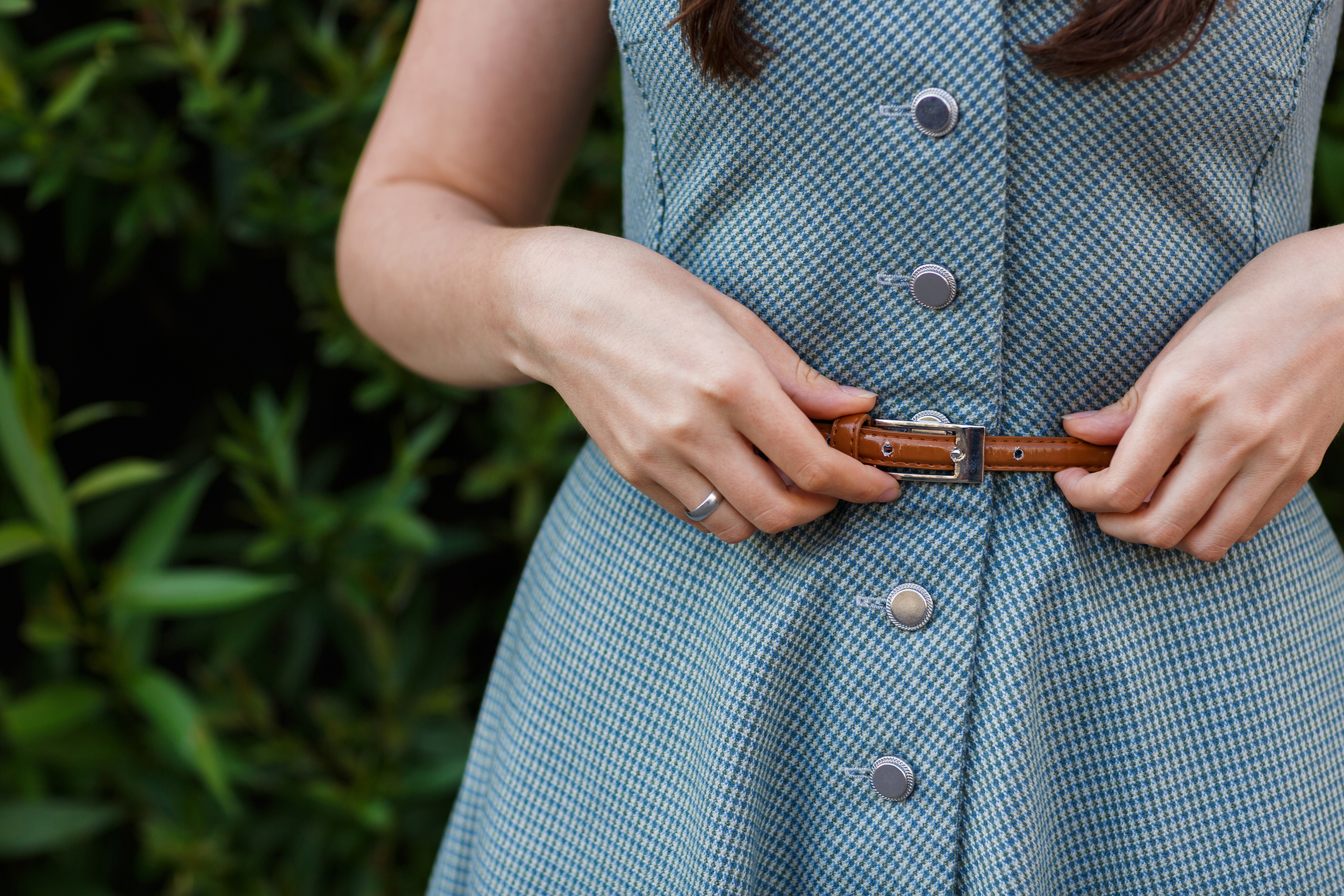 Photo of a woman adjusting her belt | Source: Shutterstock