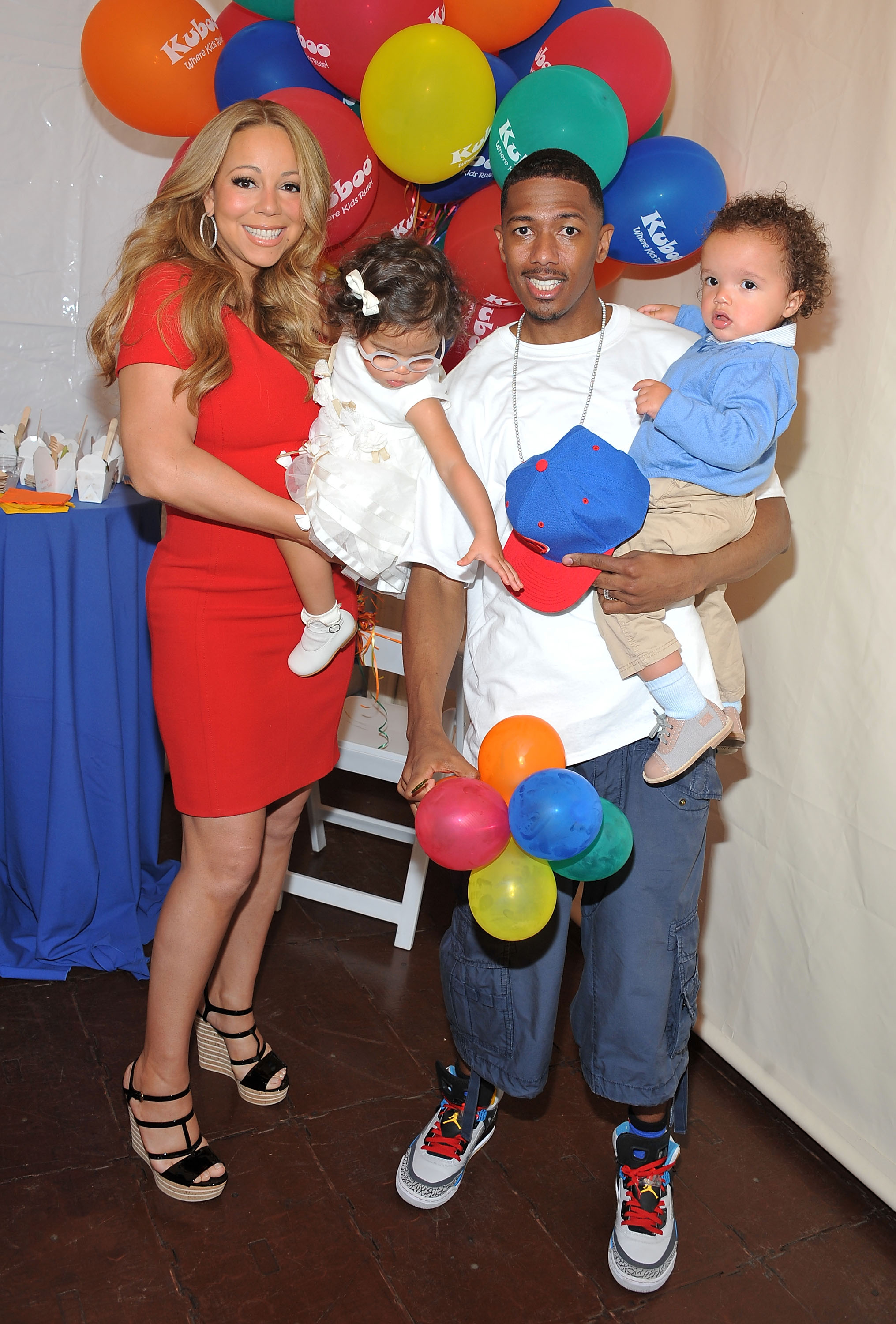 Mariah Carey and Nick Cannon pose for pictures with their twins, Monroe Cannon and Moroccan Scott Cannon, during "Family Day" at Santa Monica Pier in Santa Monica, California, on October 6, 2012.