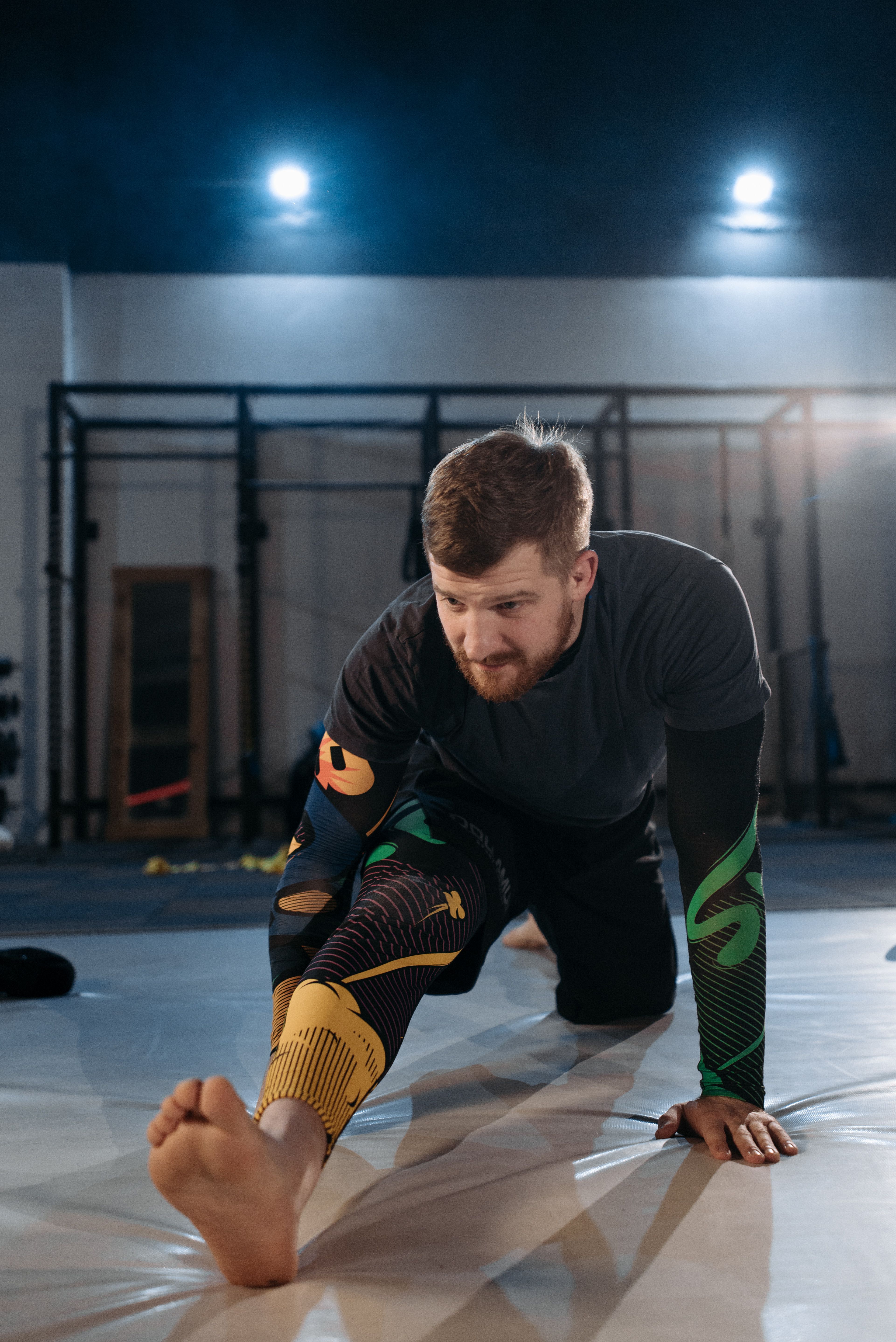 A man stretching on a gym mat | Source: Pexels