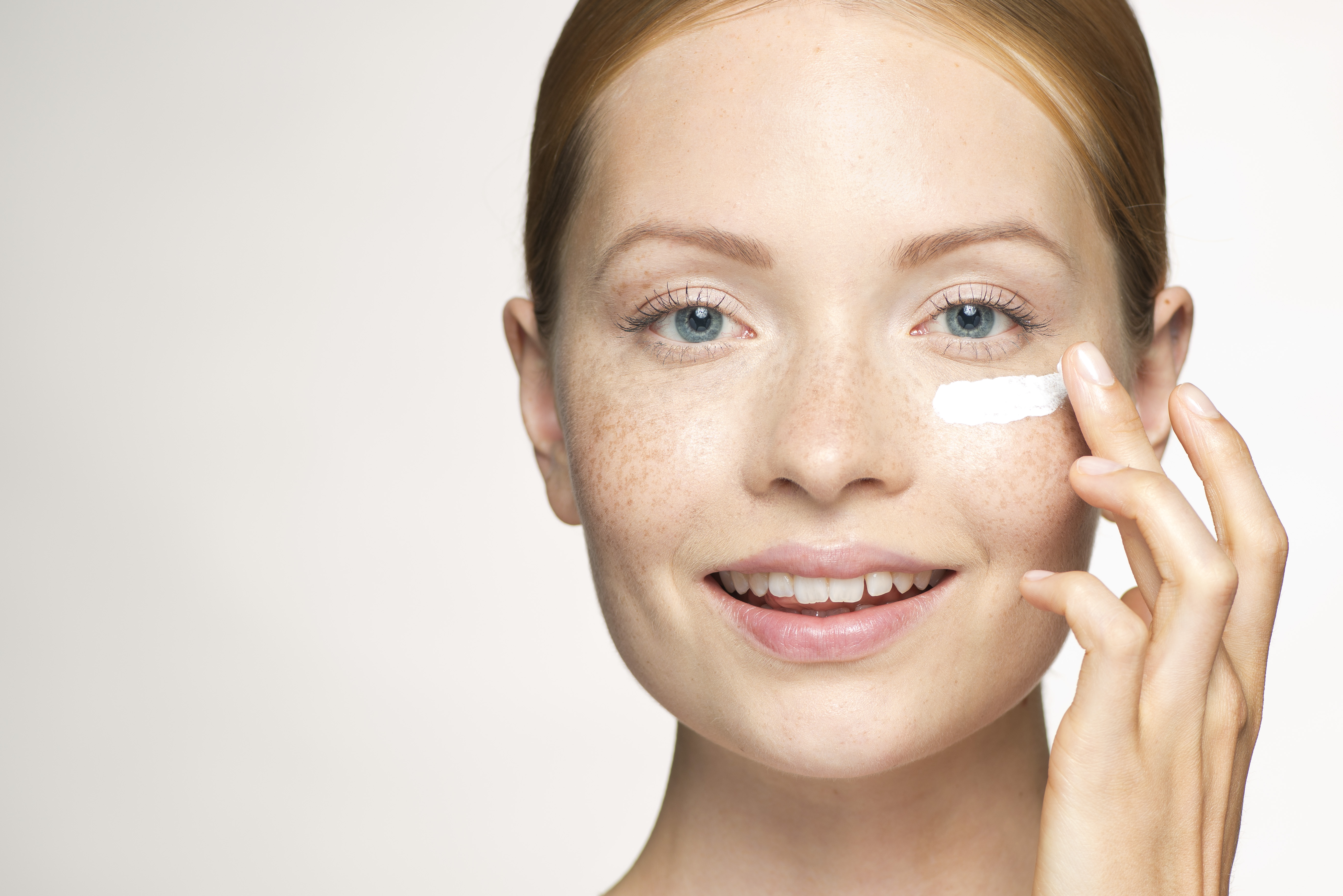 Woman applying moisturizer. | Source: Getty Images