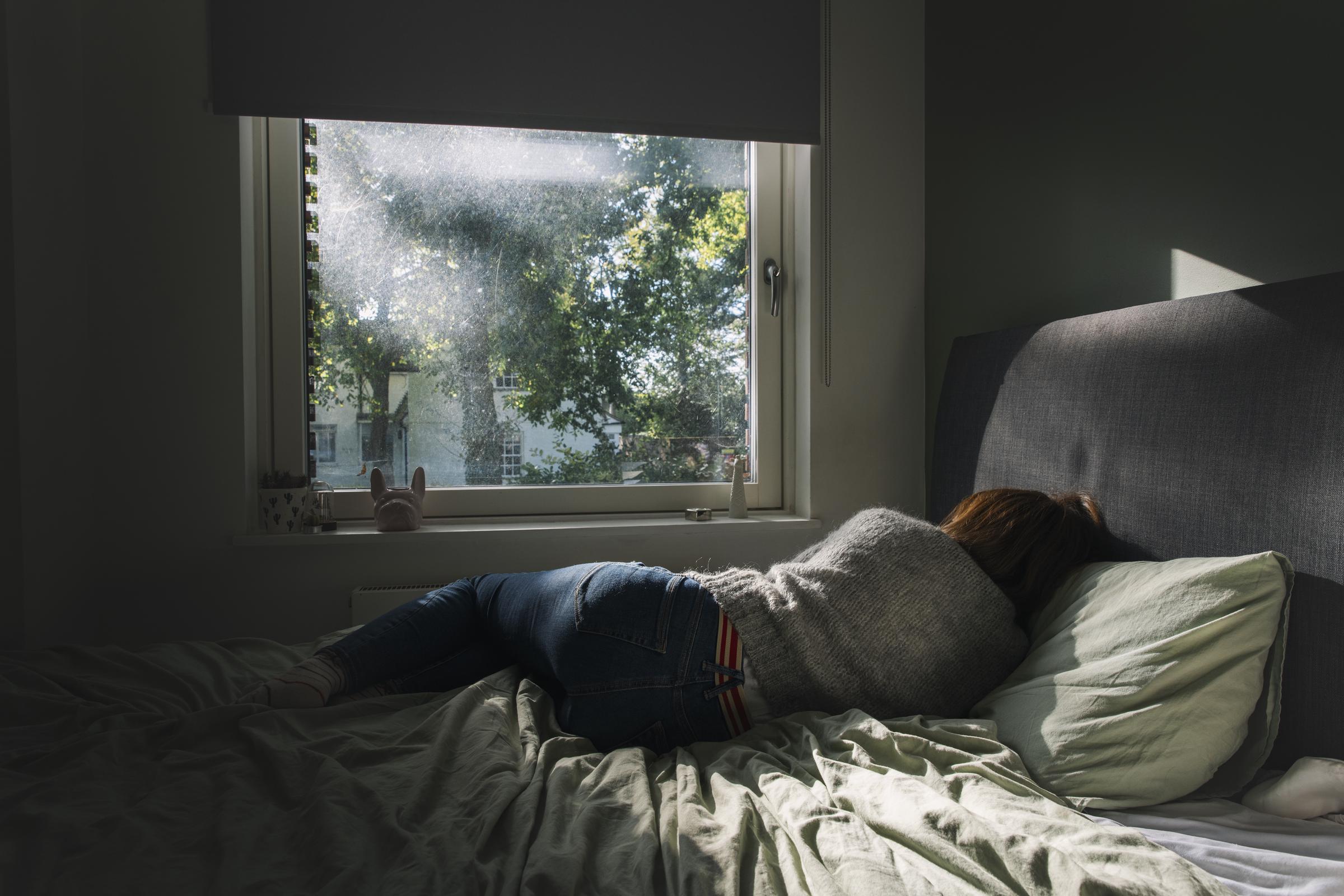 A woman lying on her bed | Source: Getty Images