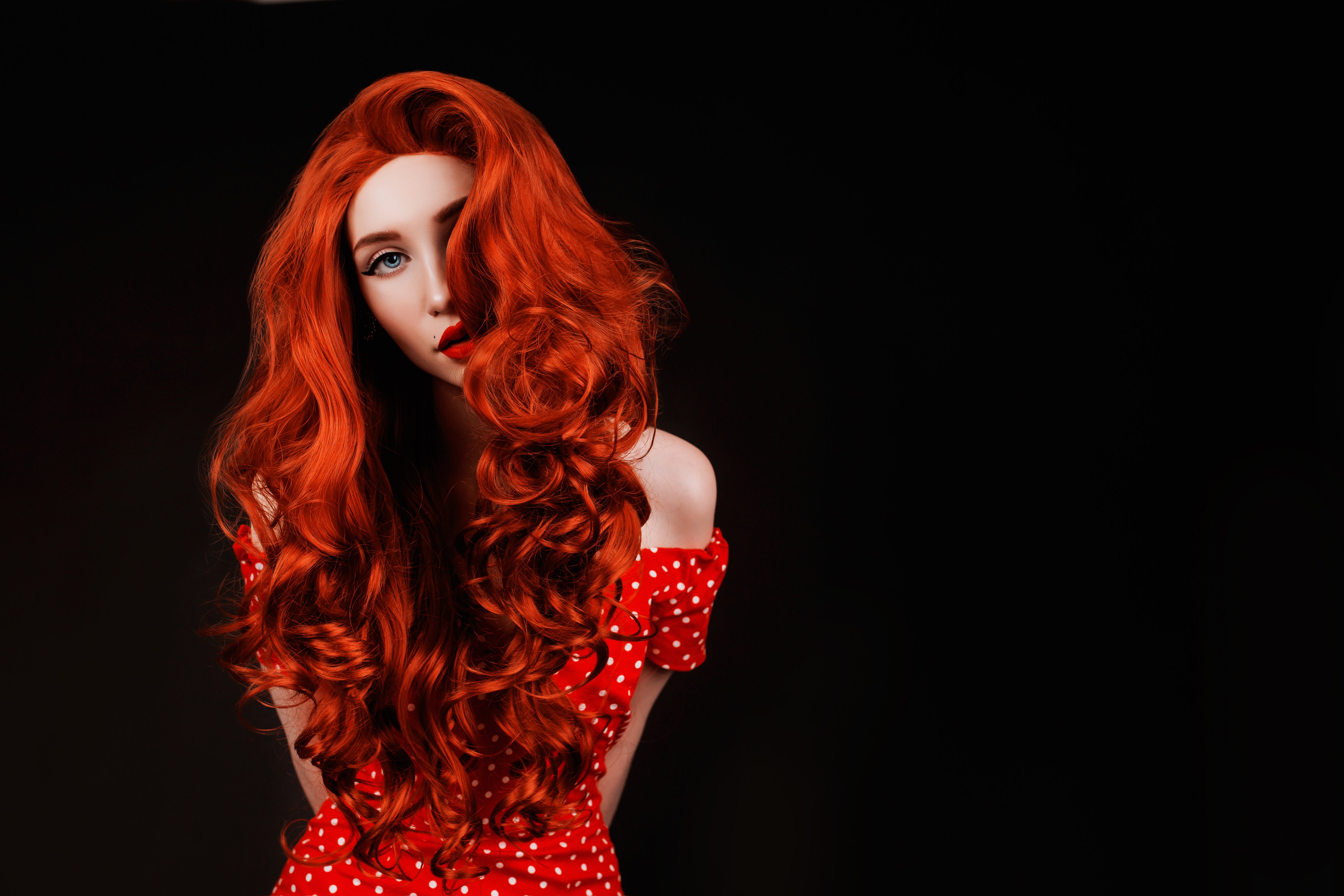 A portrait of a woman with copper hair in retro polka dot dress | Source: Getty Images