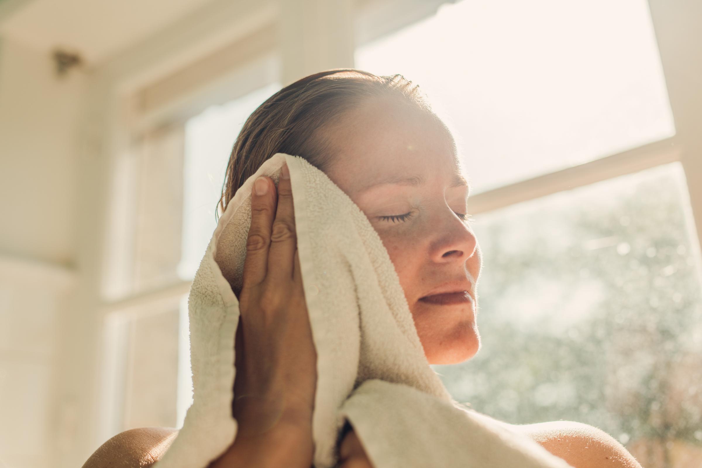 A woman toweling herself after a bath | Source: Getty Images