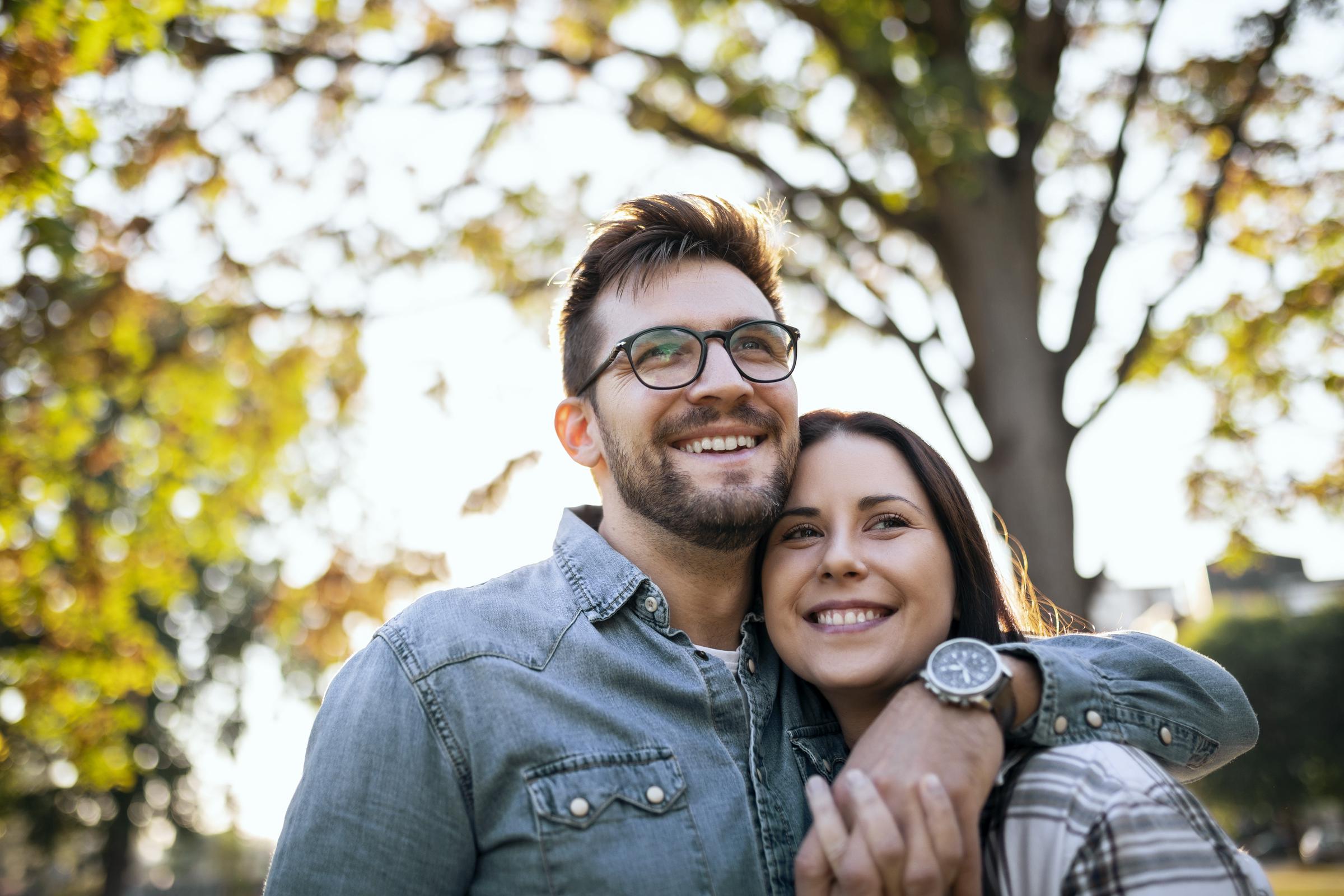 Happy couple walking in a public park | Source: Getty Images