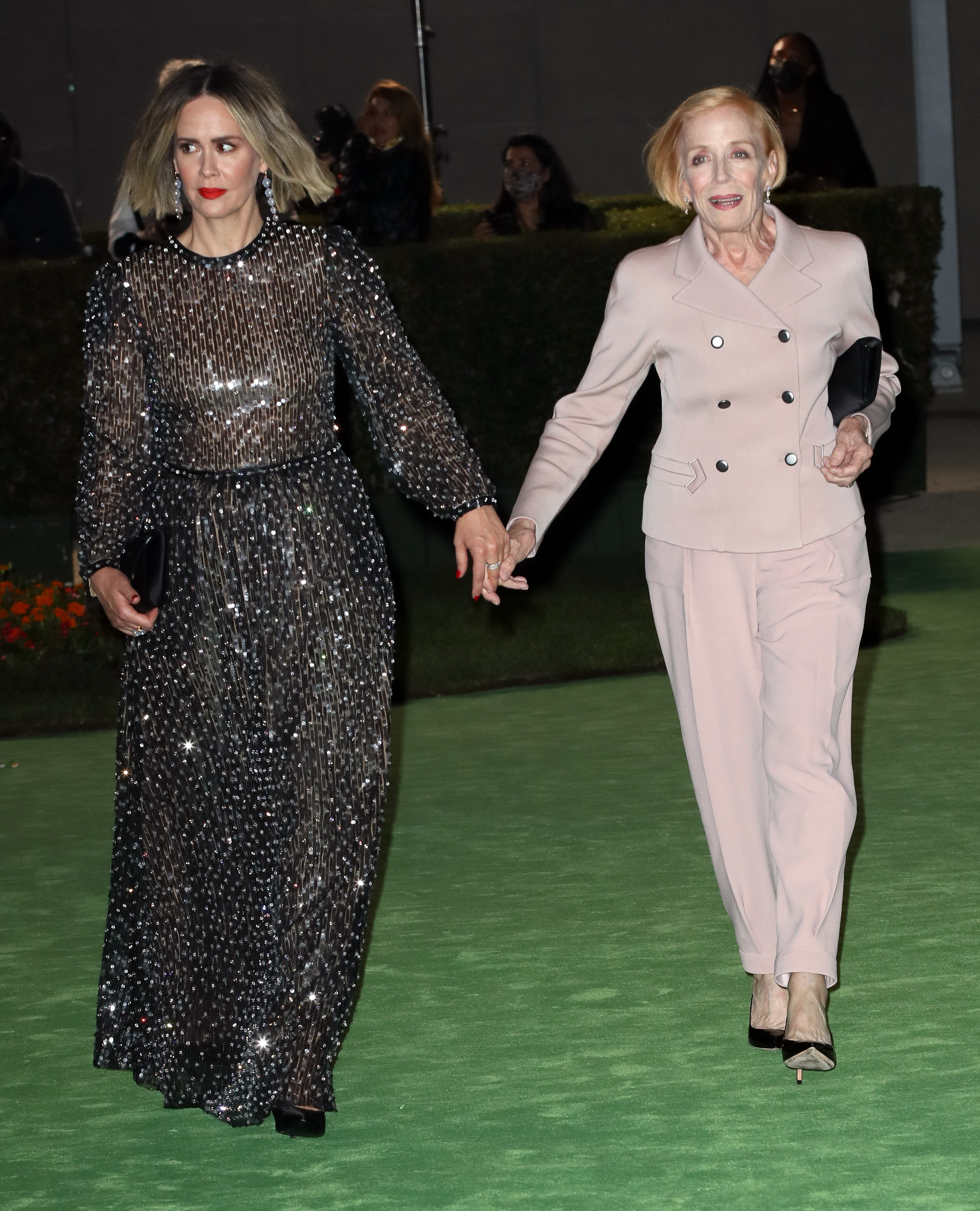 Sarah Paulson and Holland Taylor hold hands at the Academy Museum of Motion Pictures Opening Gala in Los Angeles on September 25, 2021. Taylor later praised Paulson's dedication to her friendships during an October 2026 interview. | Source: Getty Images