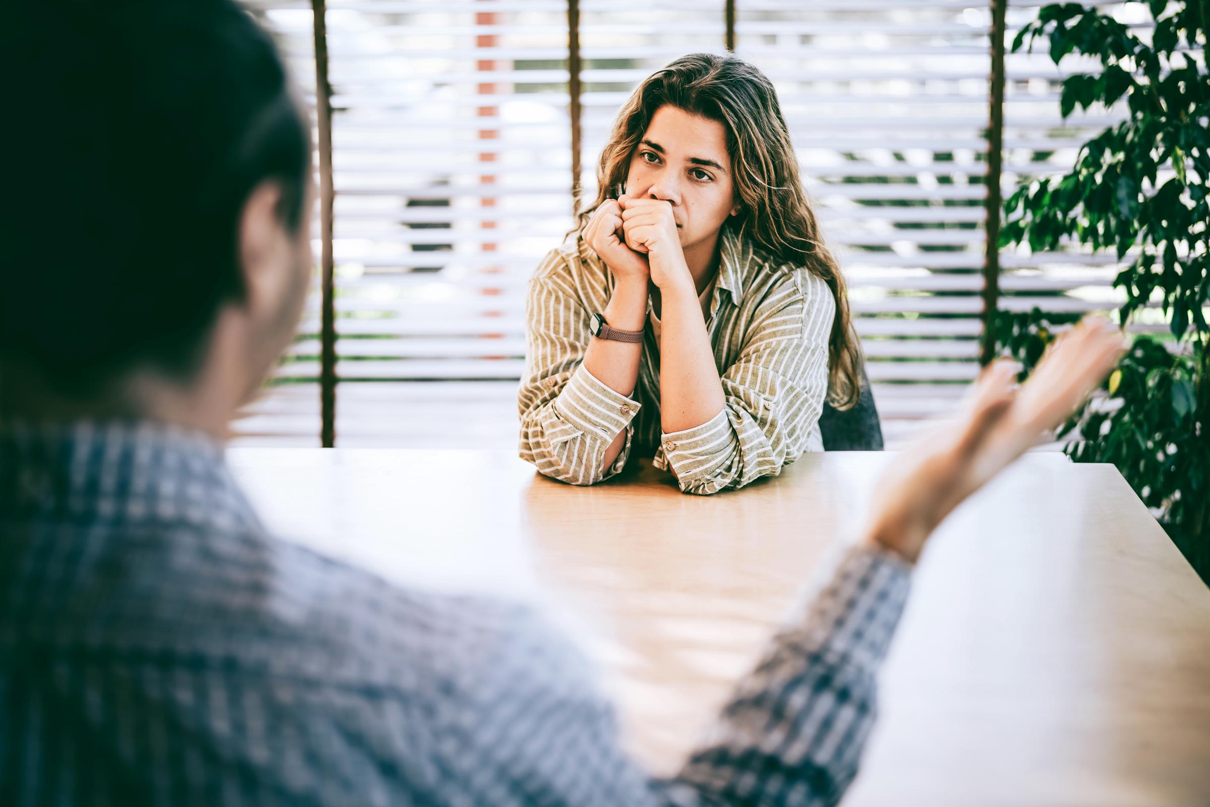A woman listening to her employer during a meeting | Source: Getty Images