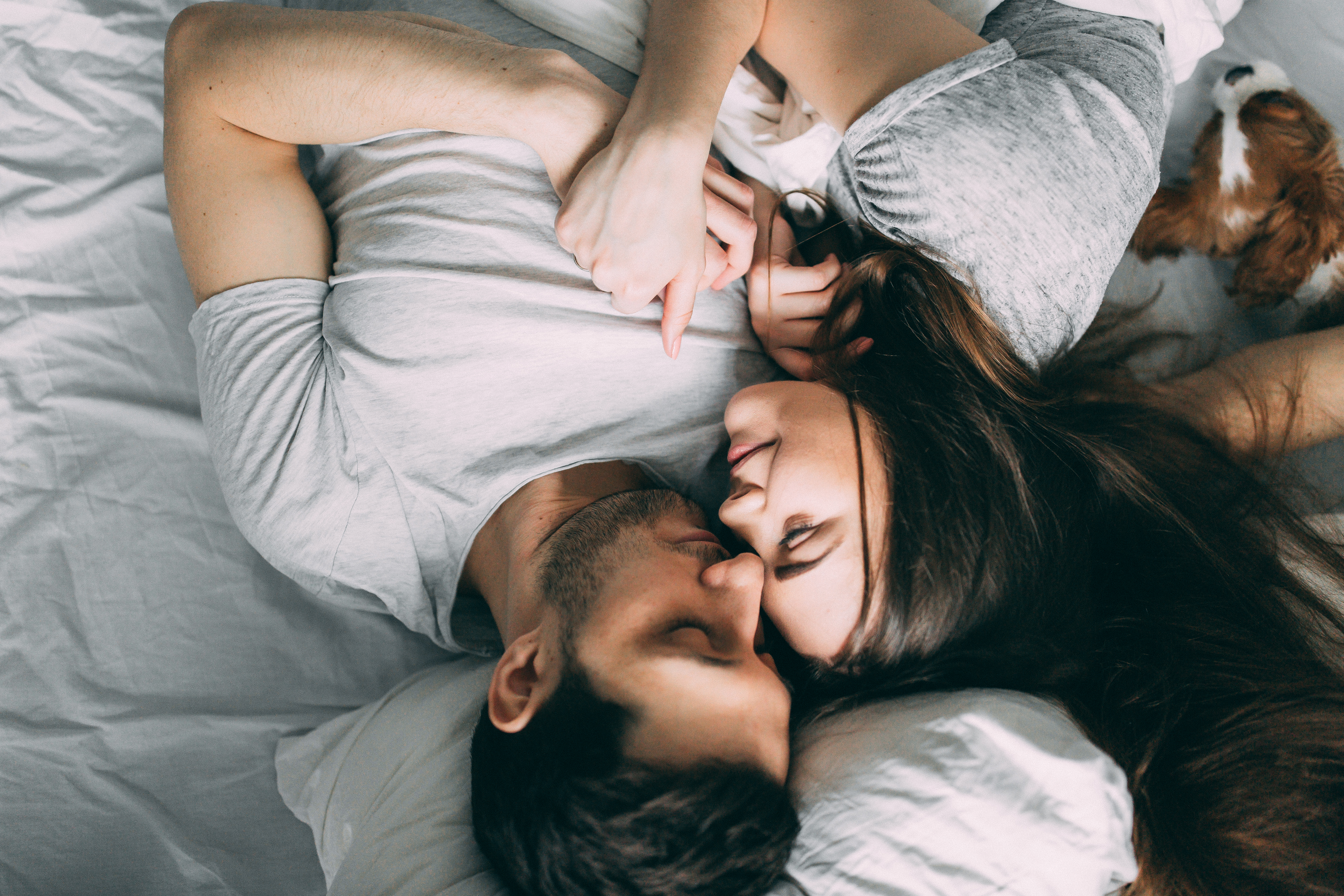 An upside-down photo of a man and woman cuddling in bed | Source: Shutterstock