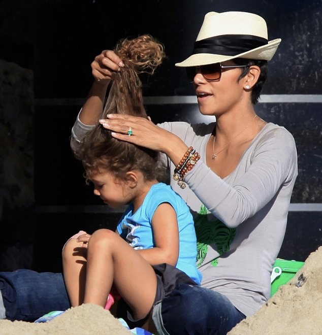 Halle Berry was photographed gently fixing little Nahla's hair during a casual outing, capturing a sweet everyday moment between mother and daughter. | Source: Getty Images