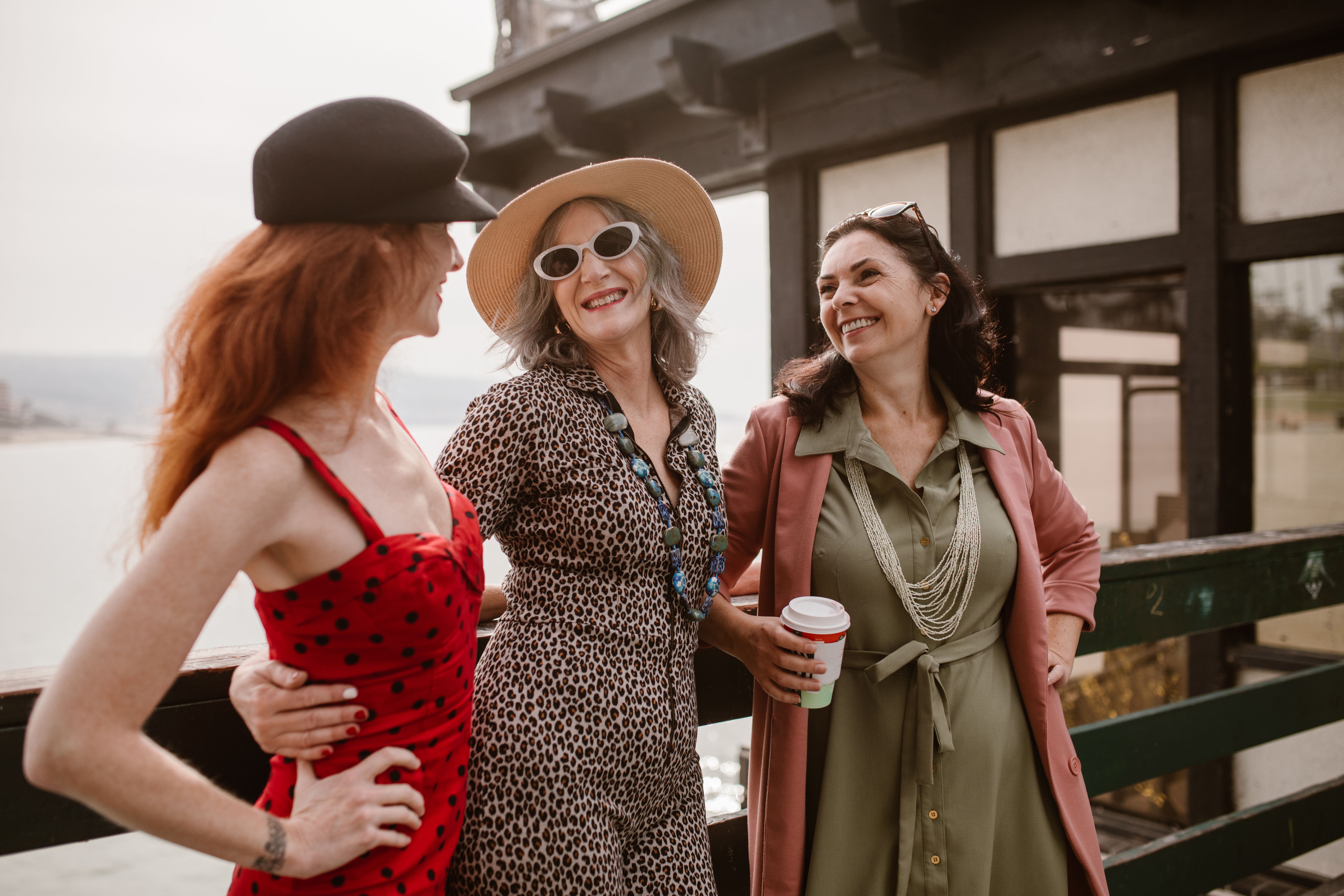 Three middle-aged women smiling at each other | Source: Pexels