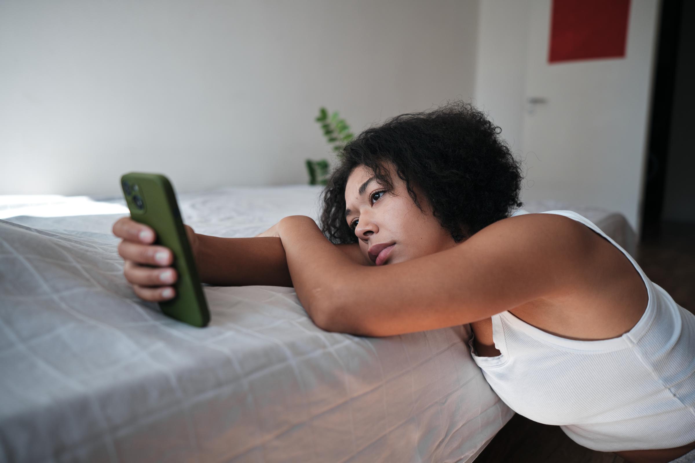 A woman scrolling on her phone | Source: Getty Images