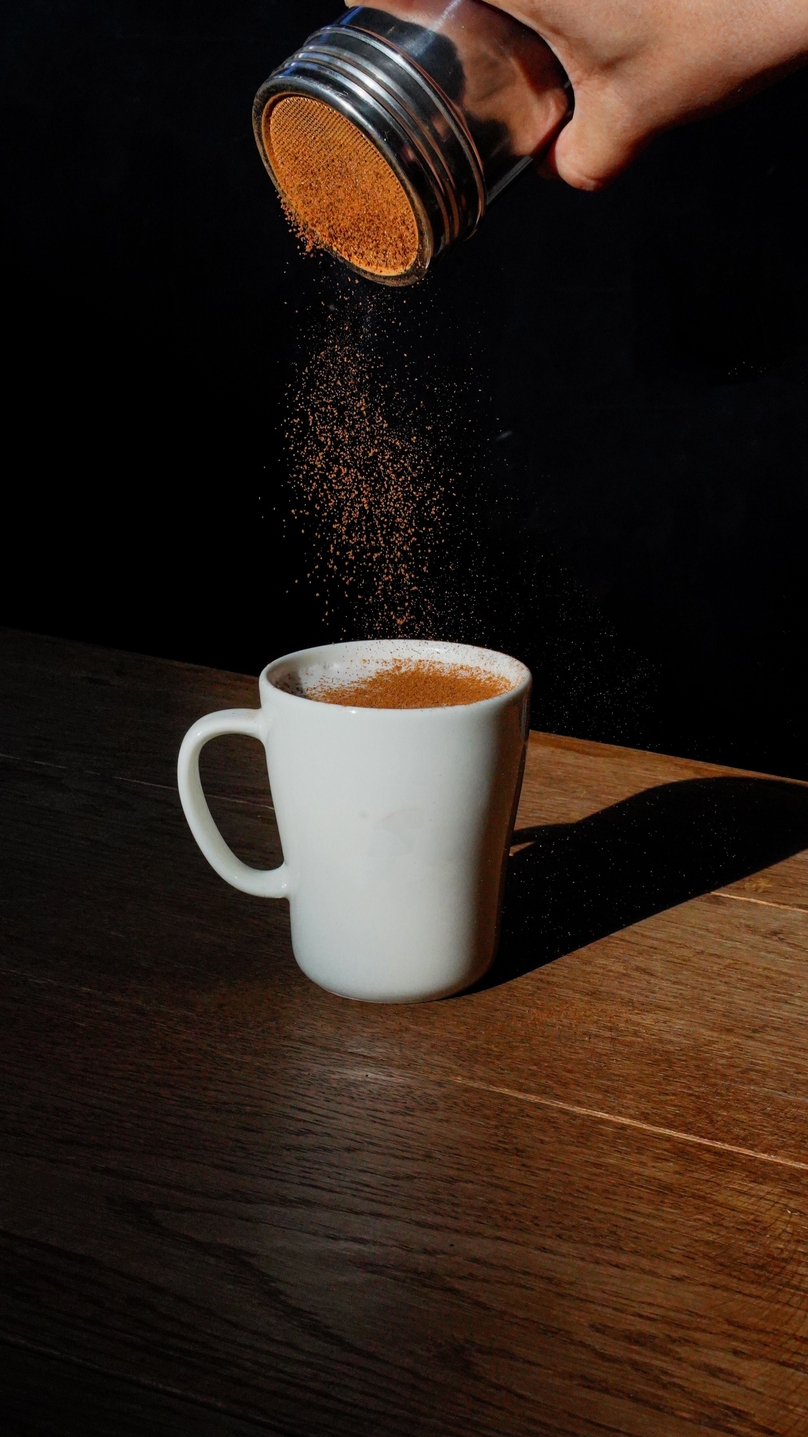 Cinnamon being added to coffee | Source: Pexels