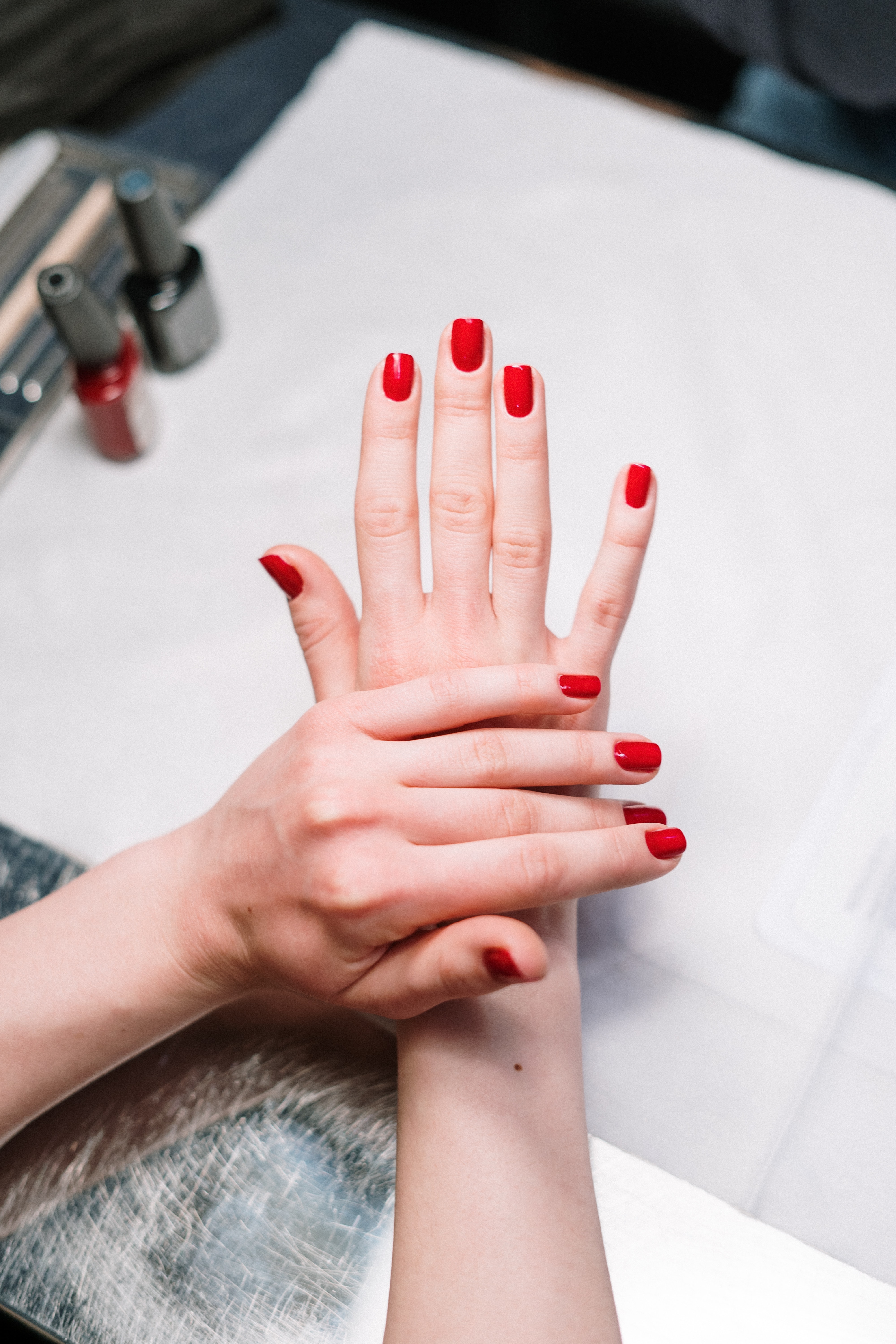 An image of a woman's manicured red nails. | Source: Pexels