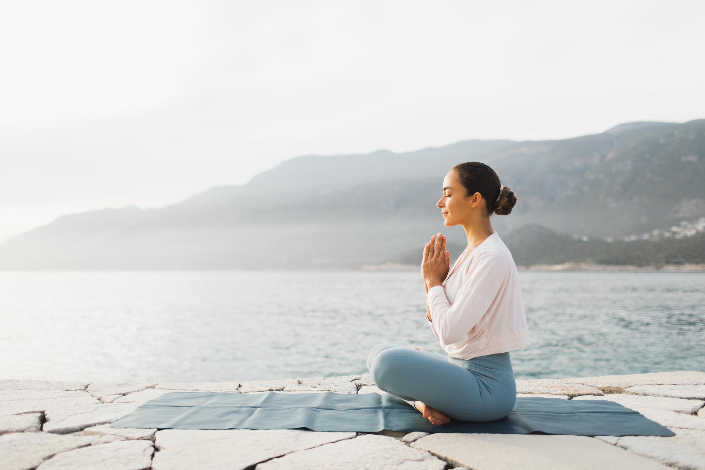 Woman practicing yoga outdoors | Source: Getty Images