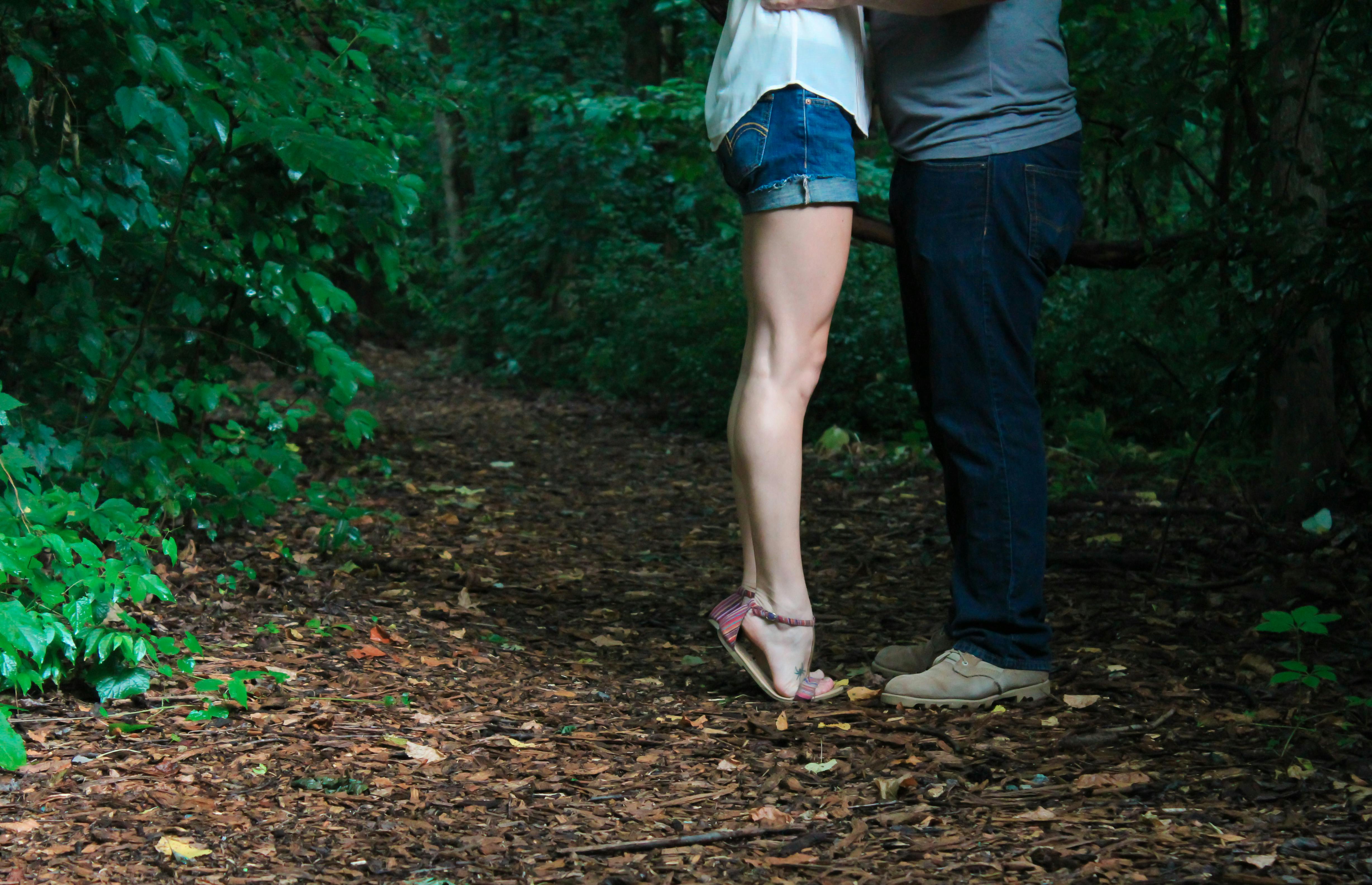 The bottom half of a couple in an intimate embrace | Source: Pexels