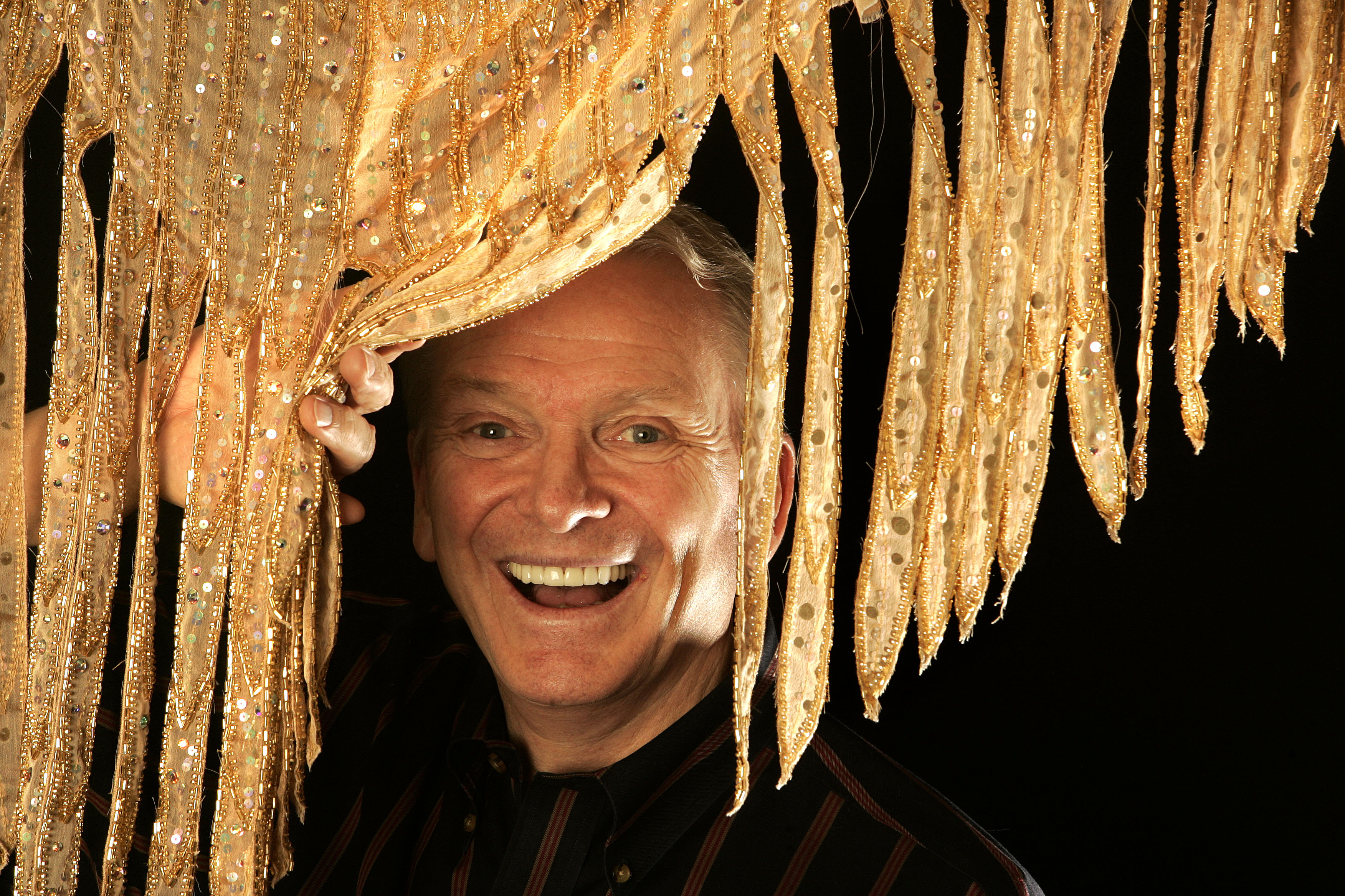 Fashion designer Bob Mackie posing behind print silk crepe de chine at his design studio in Studio City on May 9, 2008 | Source: Getty Images