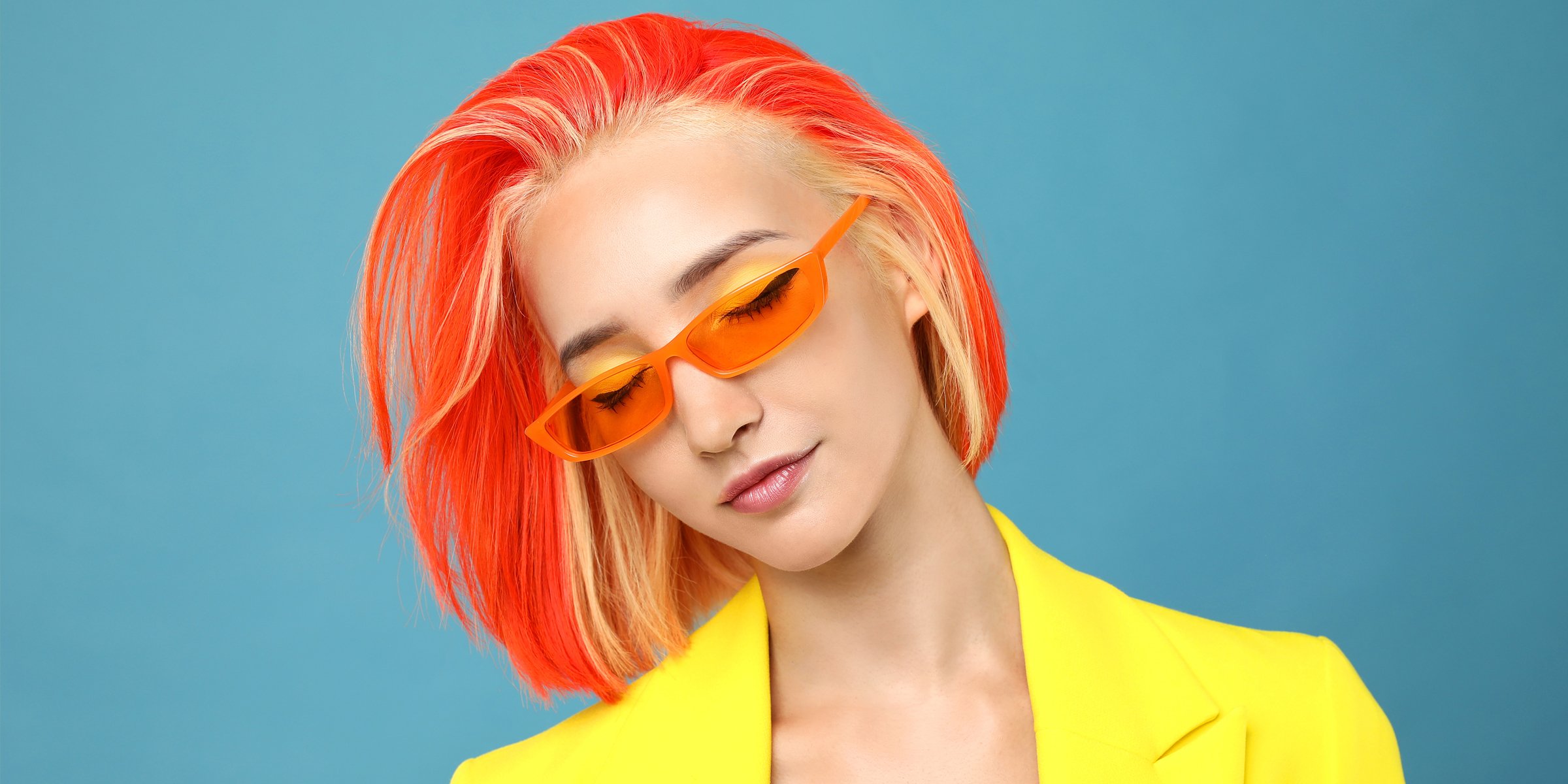 A Woman with an Orange Hair-Colored Bob Hairstyle with Blonde Highlights | Source: Shutterstock