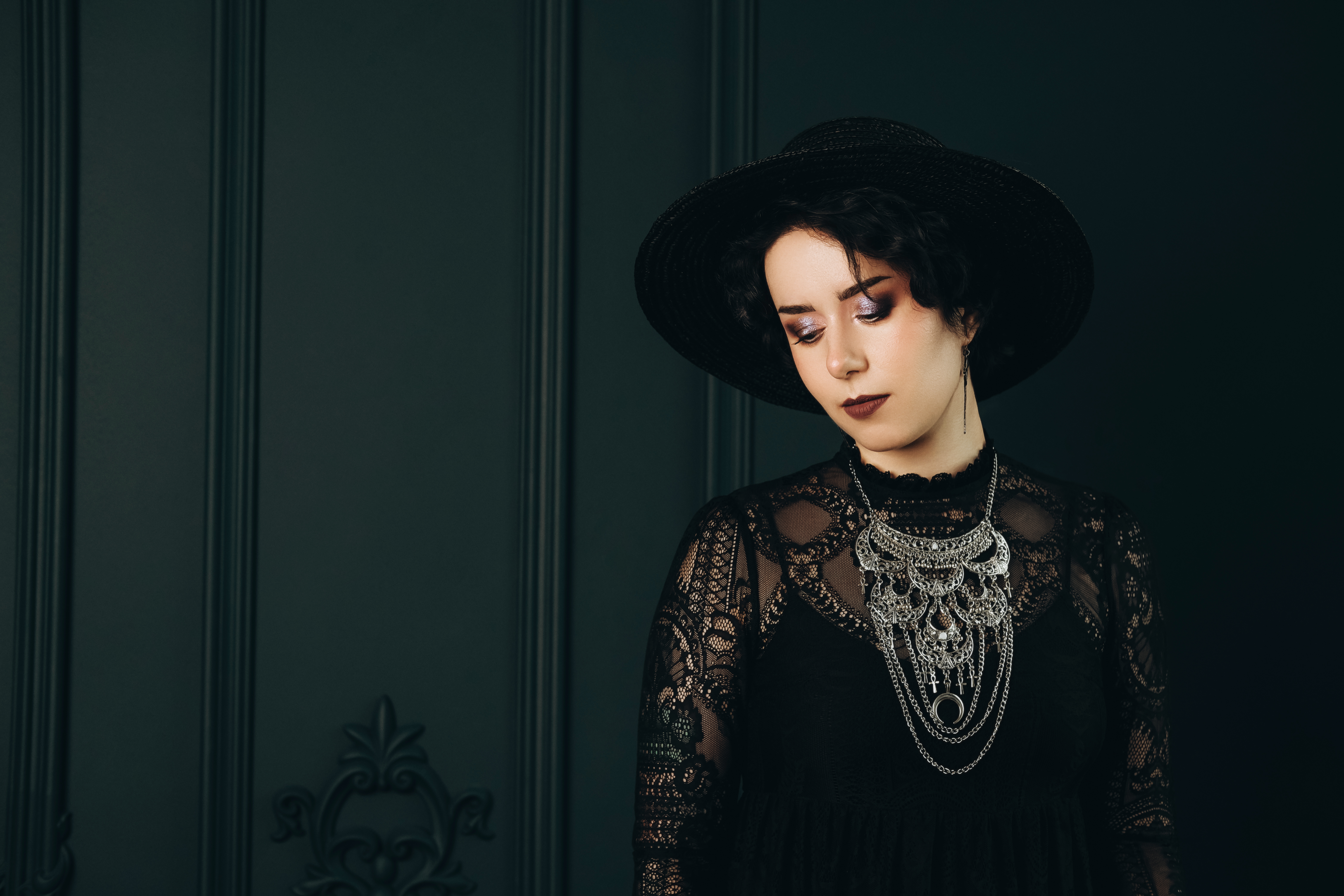 A portrait of a young woman in goth make-up posing in dark room | Source: Getty Images