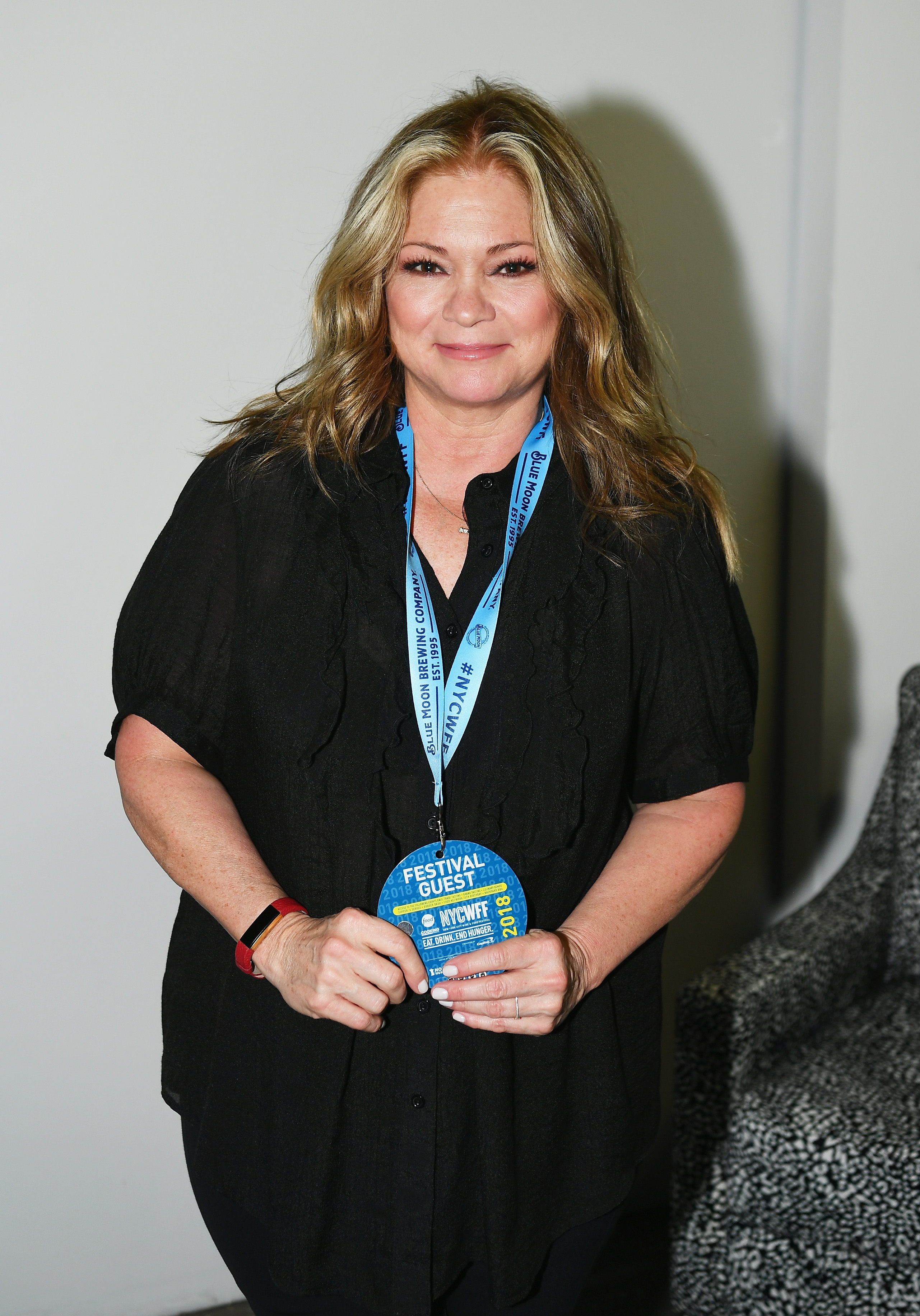 Valerie Bertinelli poses backstage at the Food Network & Cooking Channel New York City Wine & Food Festival Presented by Capital One Grand Tasting. Her hair, styled in shades of blonde with sleek, straight curls, marks a striking change from her previous looks.