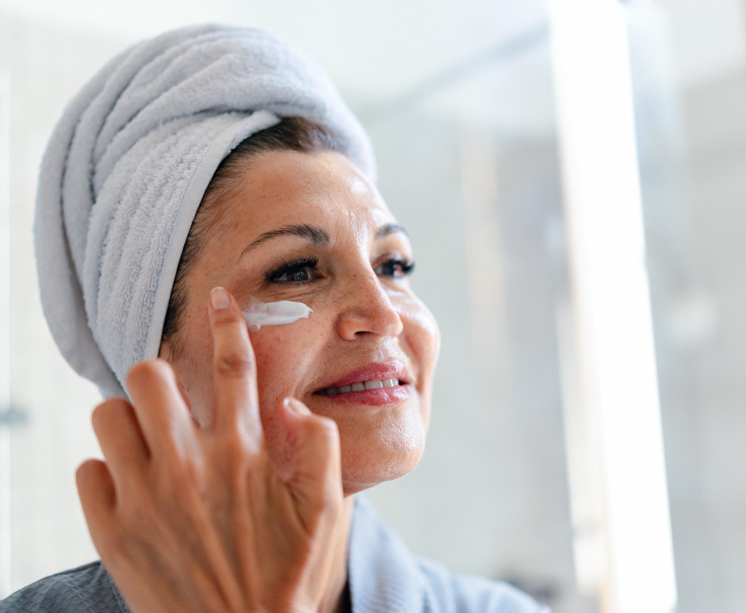 A woman applying face cream | Source: Getty Images