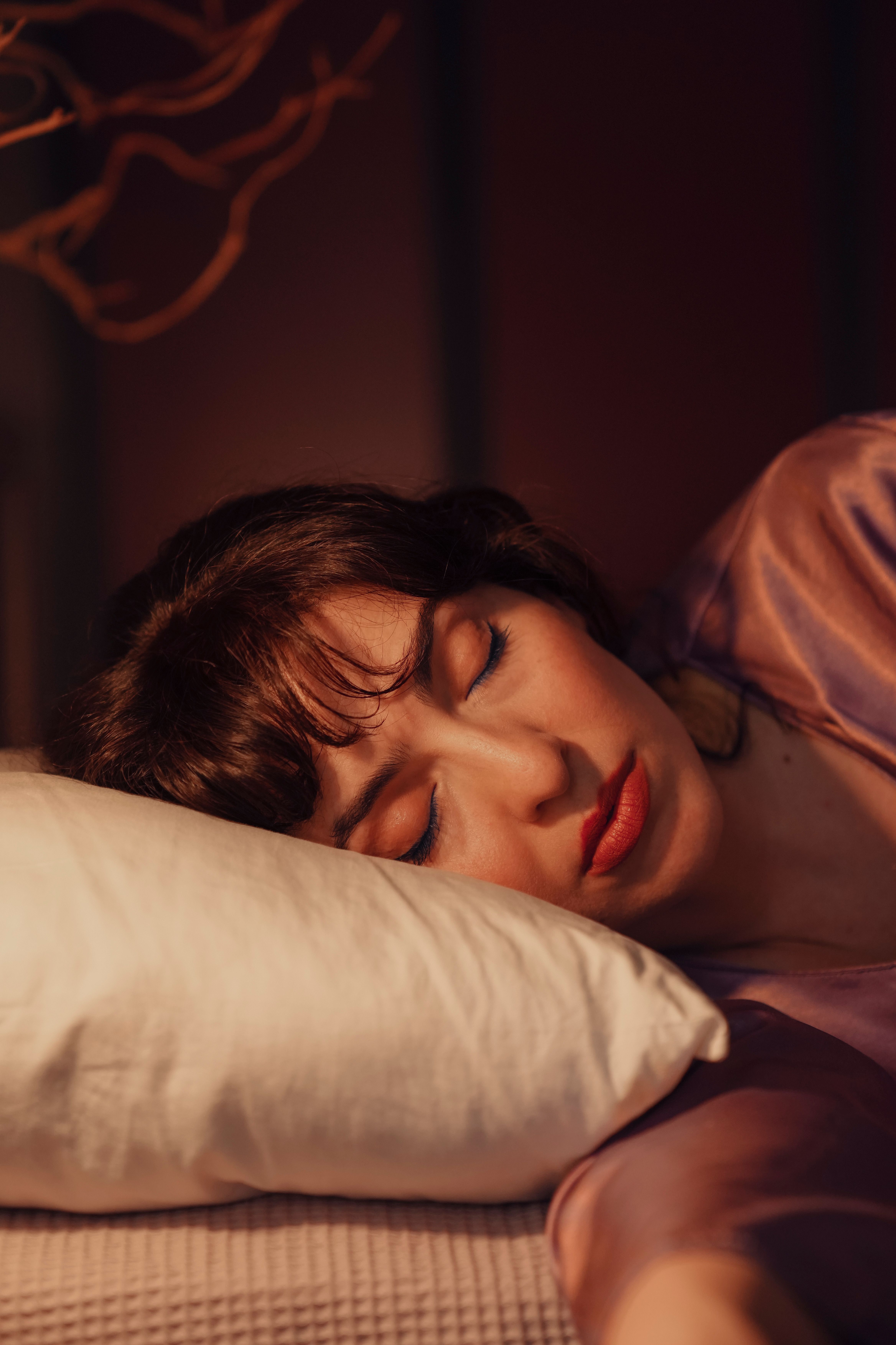 A woman sleeping with the light on | Source: Pexels