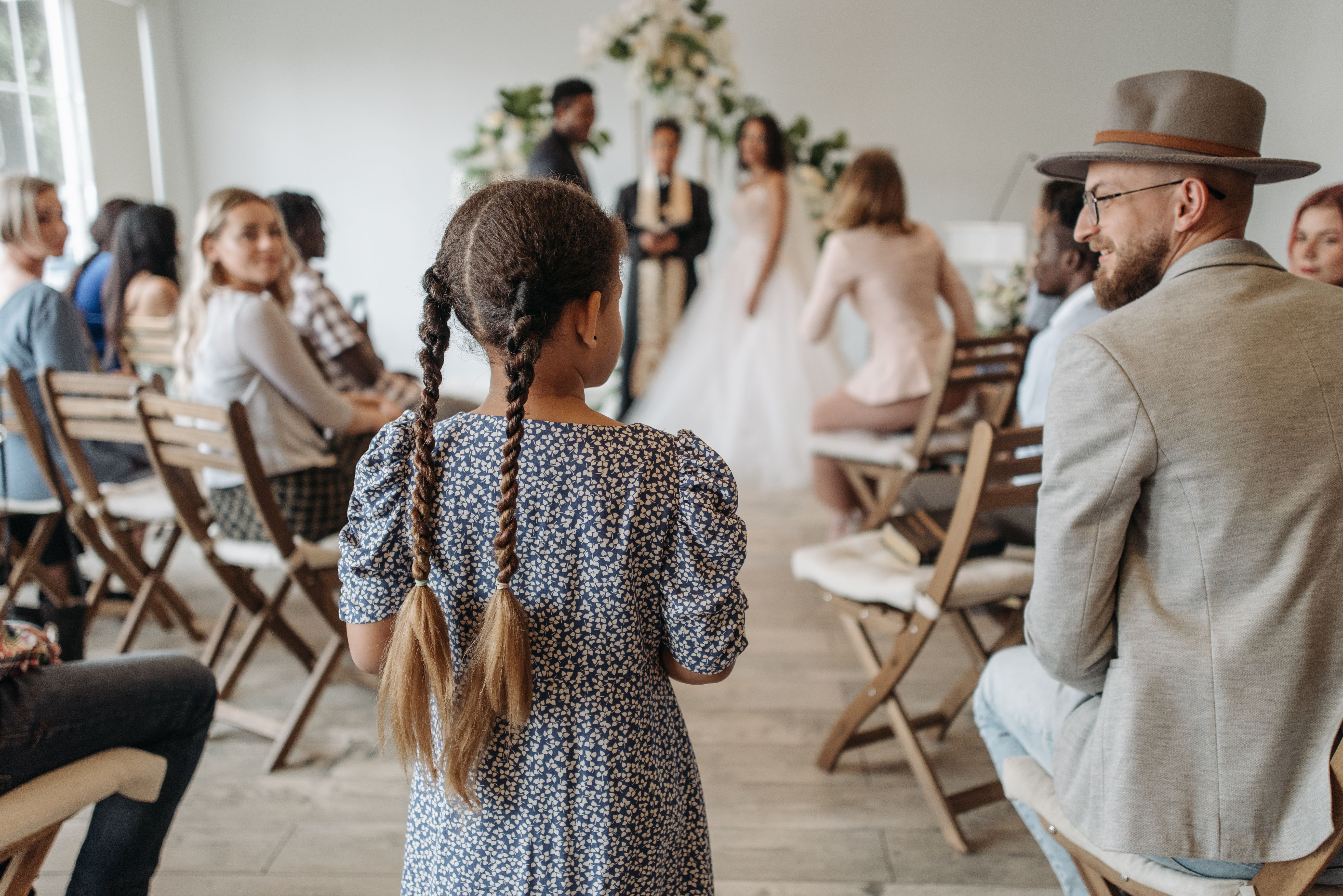 Man and a young girl at a wedding | Source: Pexels